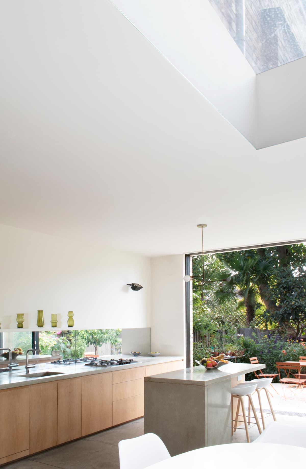 A rooflight brings daylight over the kitchen and garden-facing opening at Structuralist House.