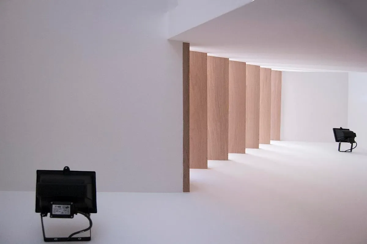 Open timber stair treads contrast with white walls at Modern Terrace.