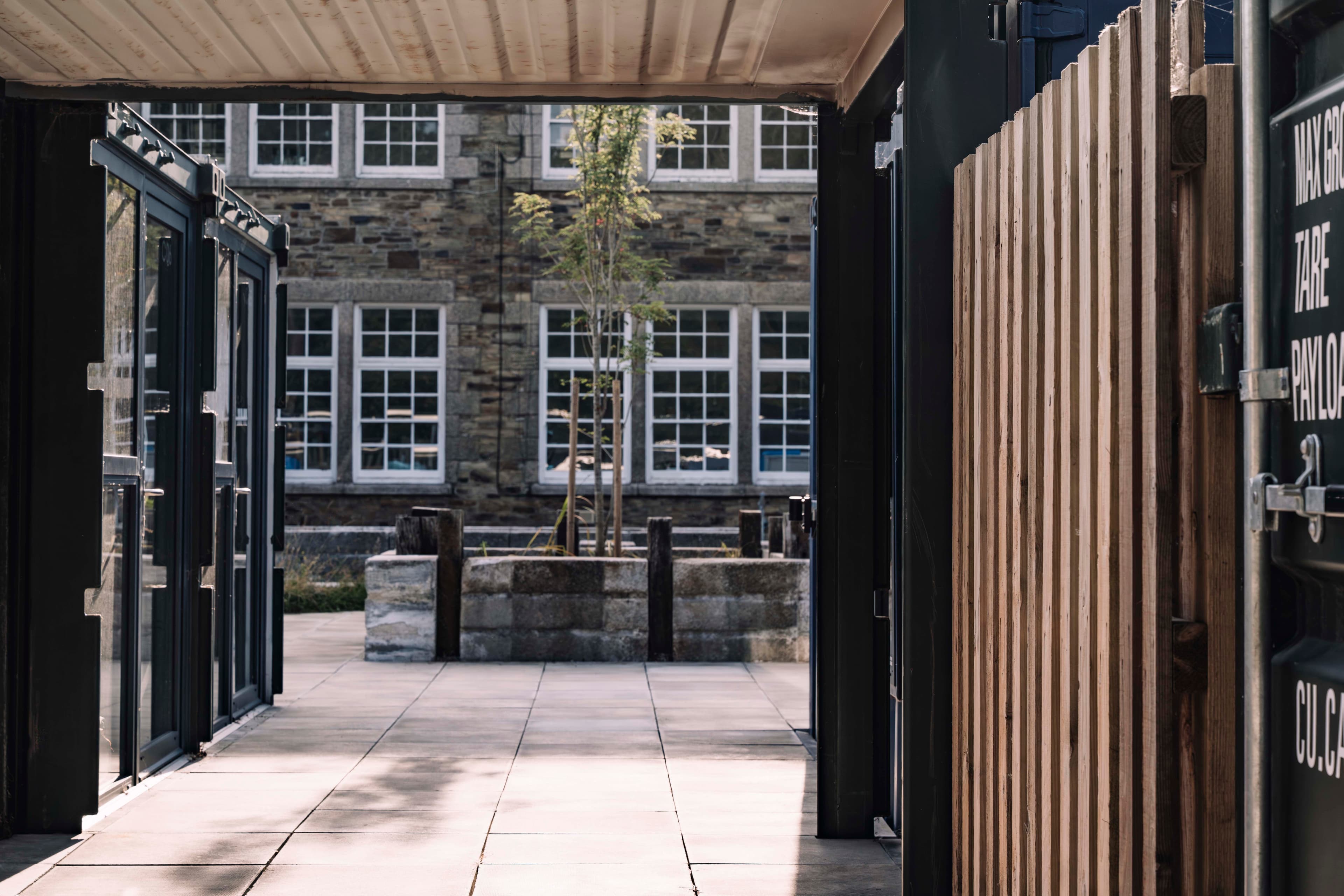An open studio door frames the shared landscape.