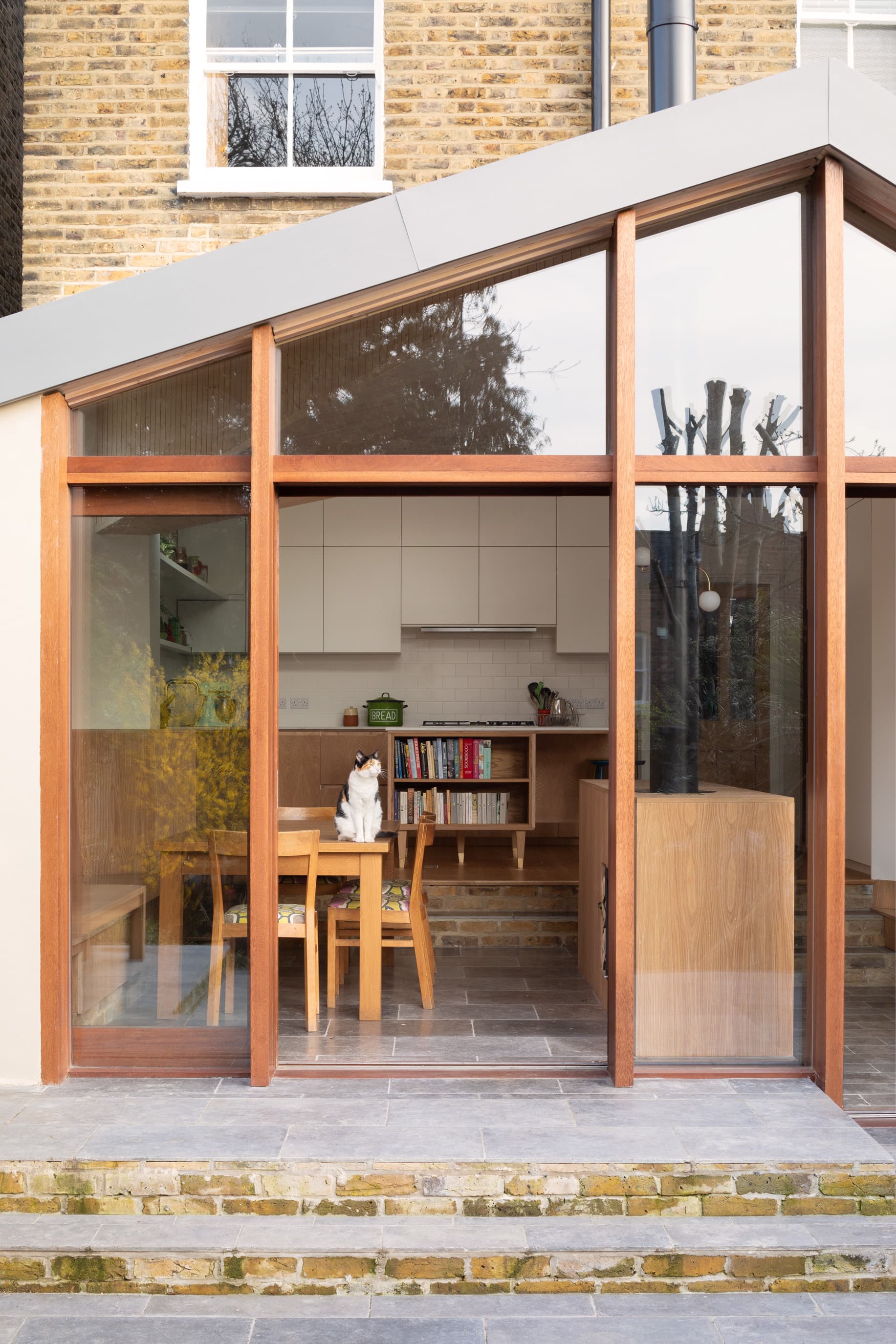 Timber-framed glazing opens the extension towards the garden.
