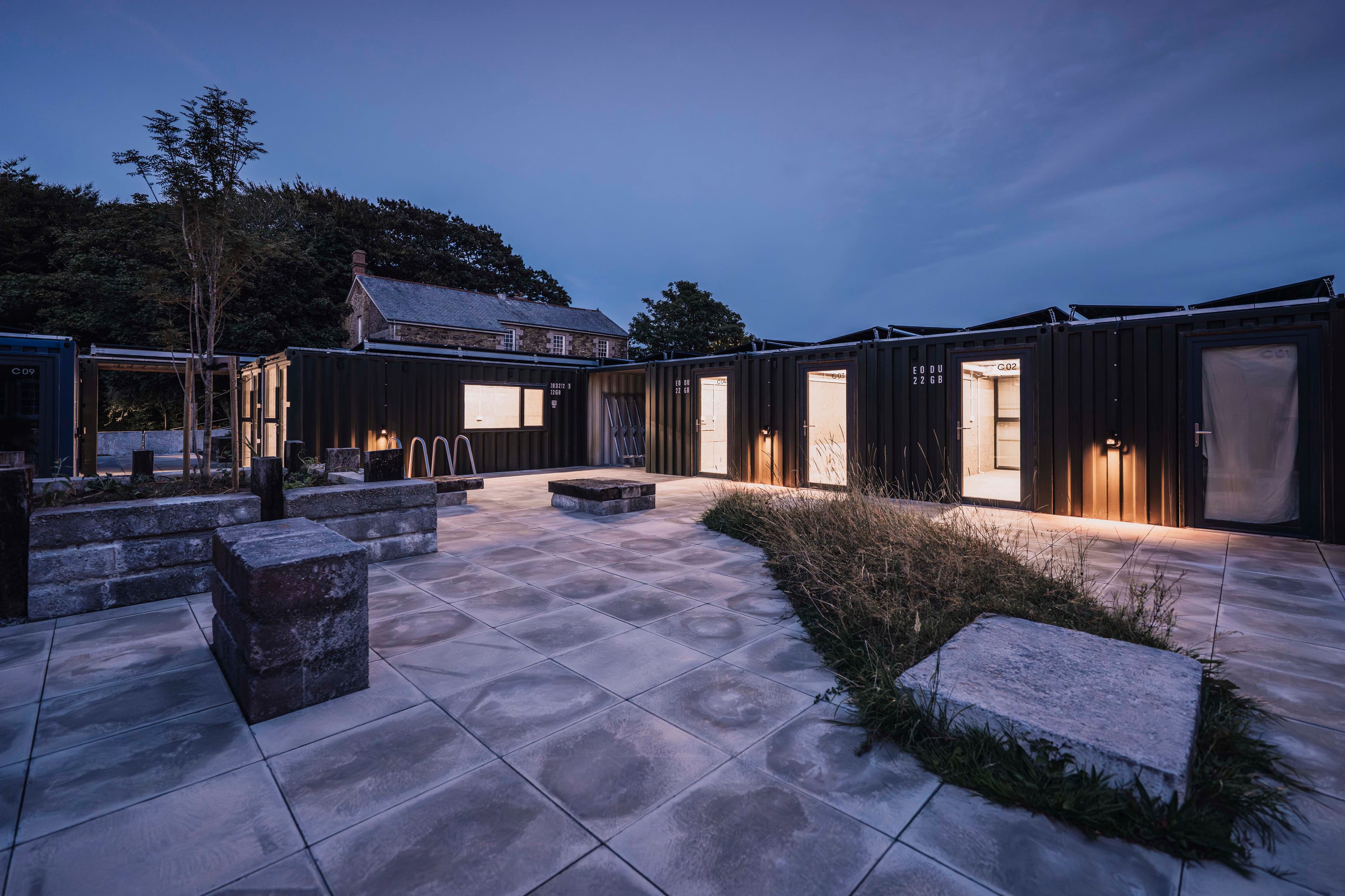 The new studios and landscaped courtyard after dusk.