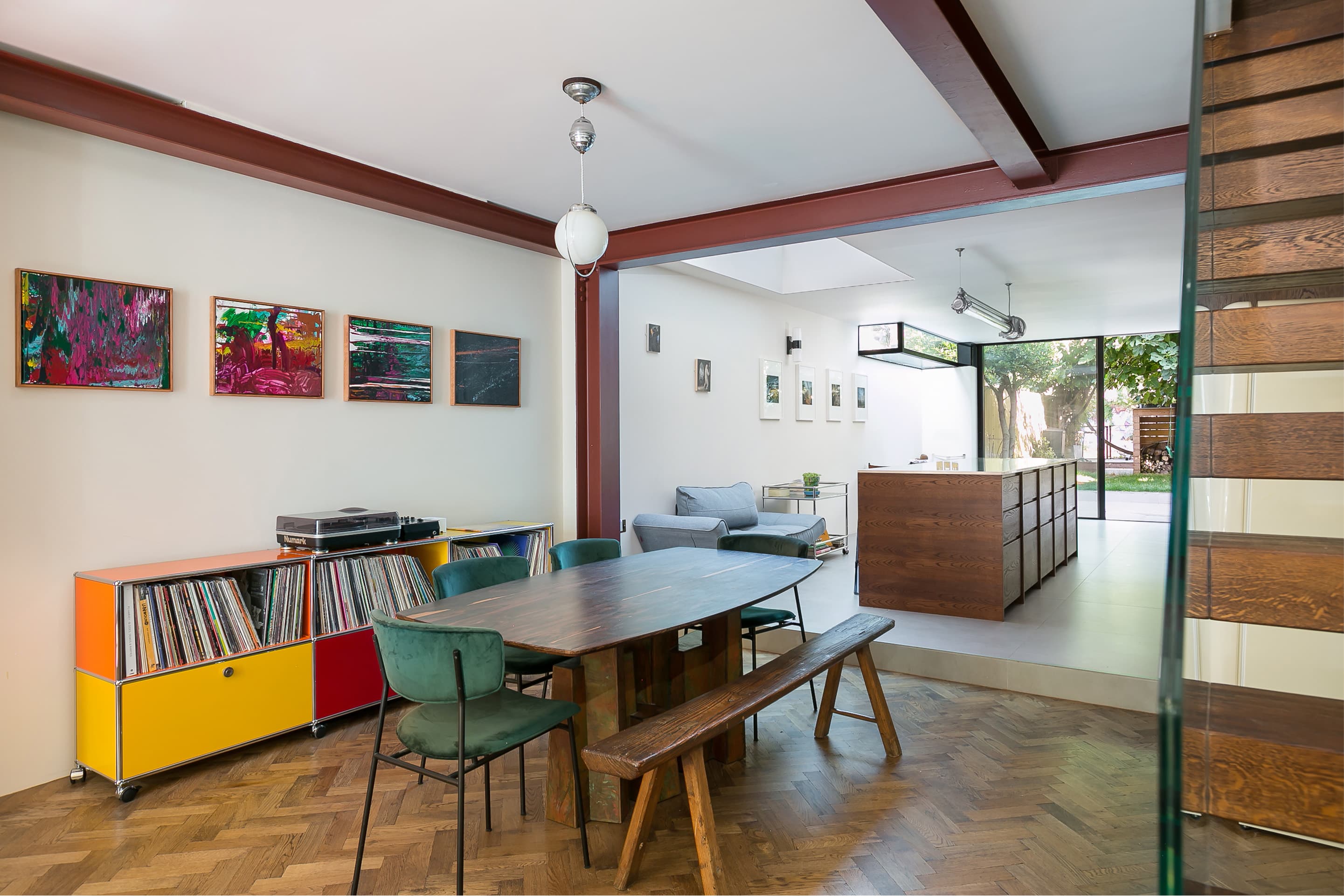Red steelwork runs above the dining and living spaces.