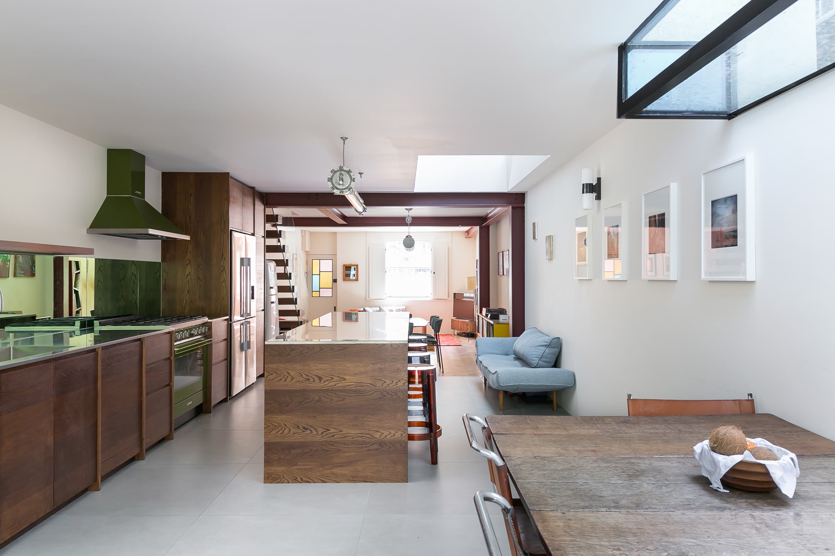 Rooflights organise the open-plan kitchen, dining and sitting spaces.