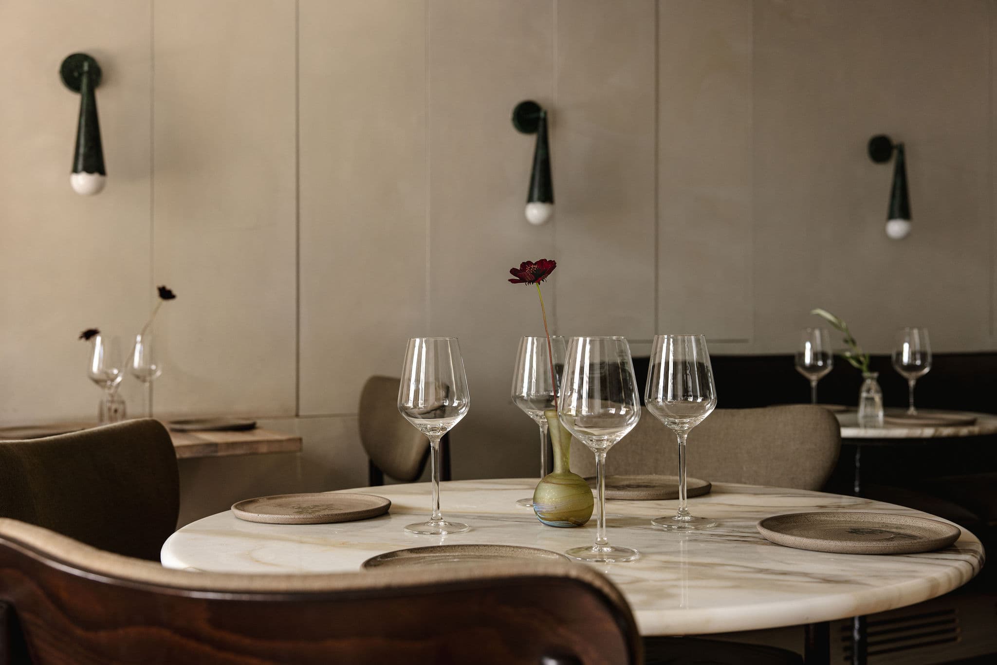 Glassware and table settings against textured plaster walls.
