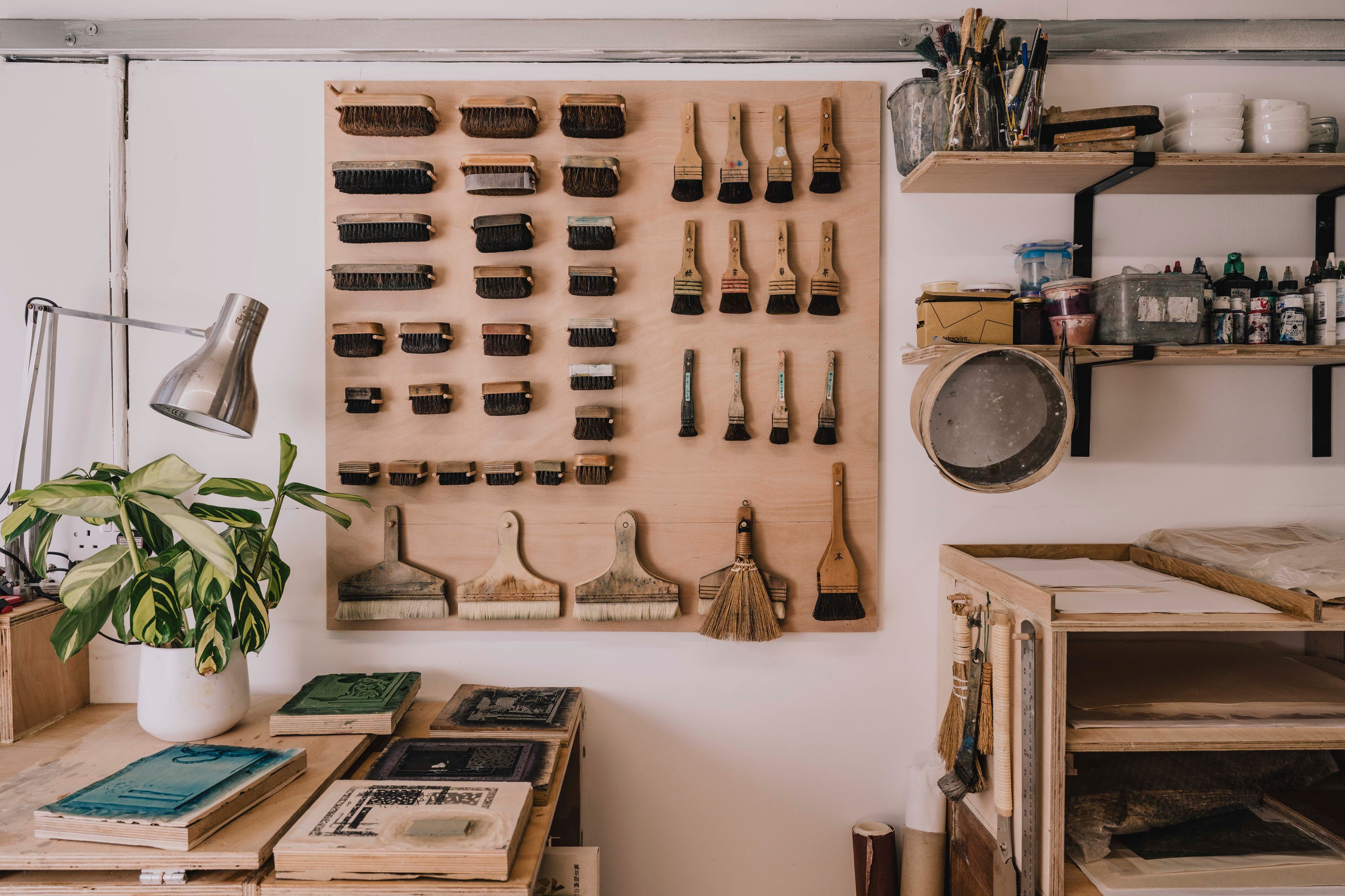 Tools and materials line the walls of a working studio.