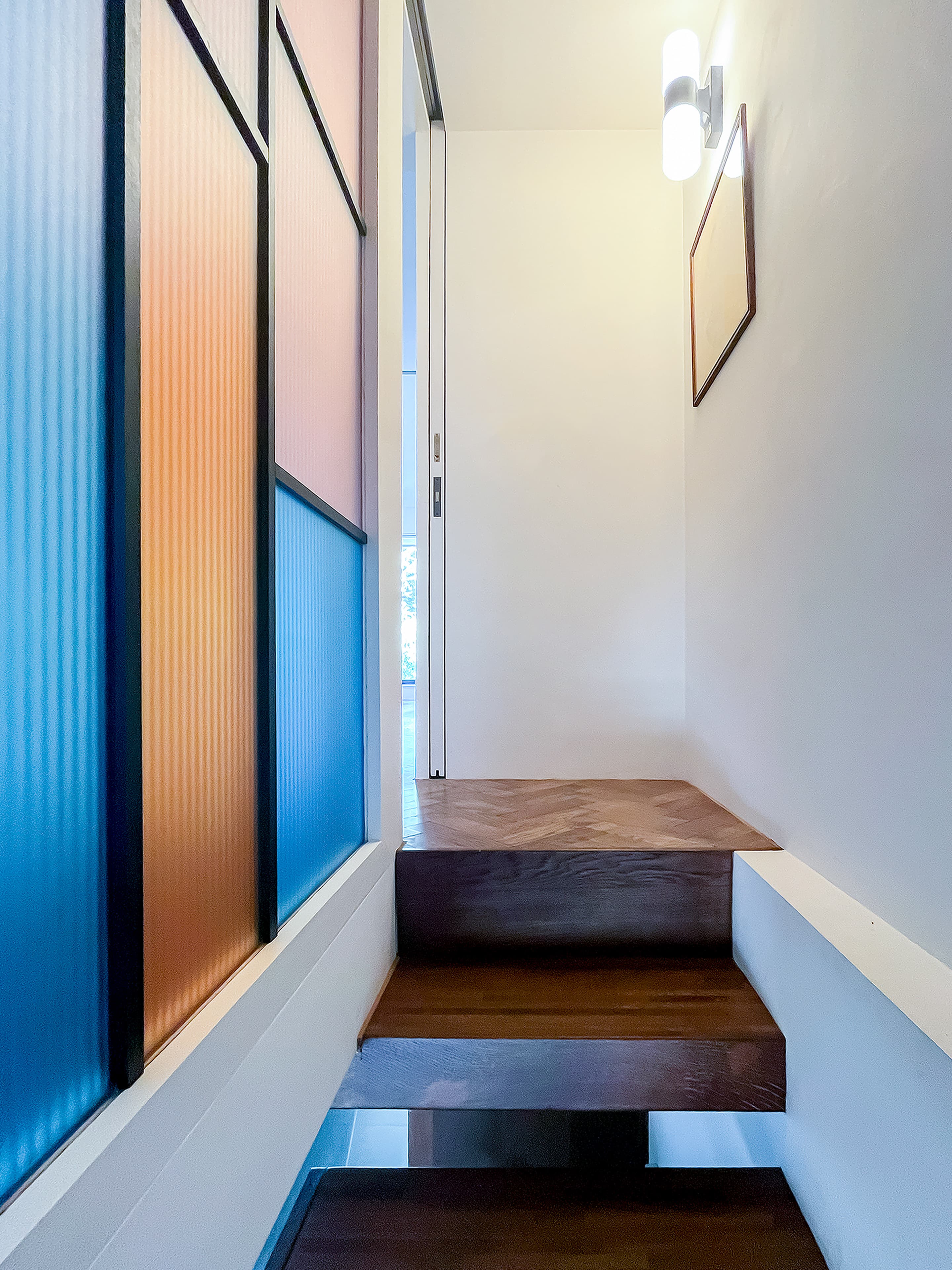 Coloured glazing recalls the original front door.