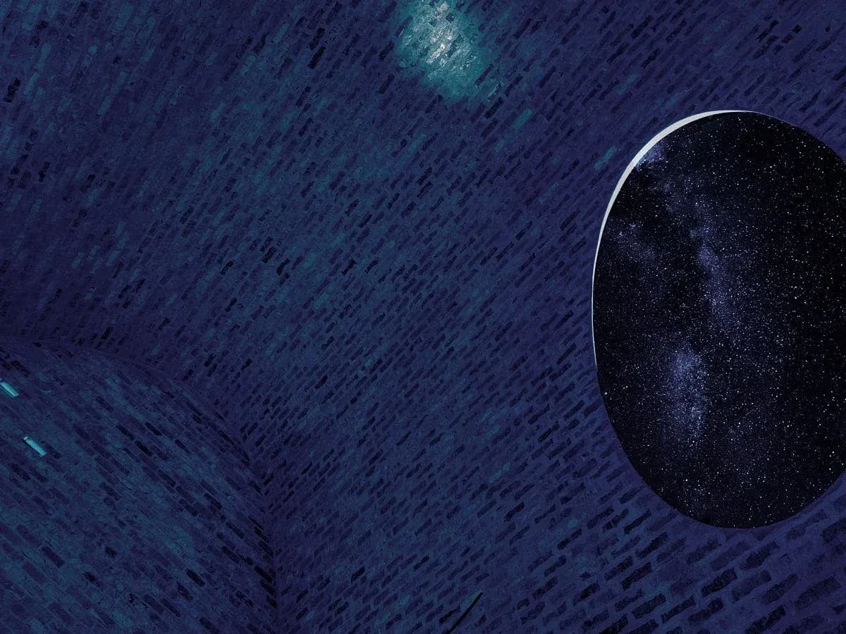 The open skylight frames a view of the stars from the vaulted room.