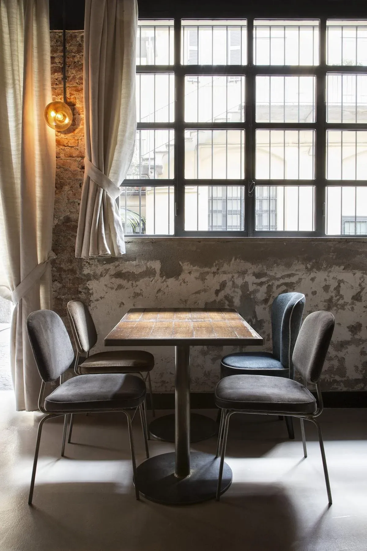 Window-side seating uses the height and daylight of the existing room.