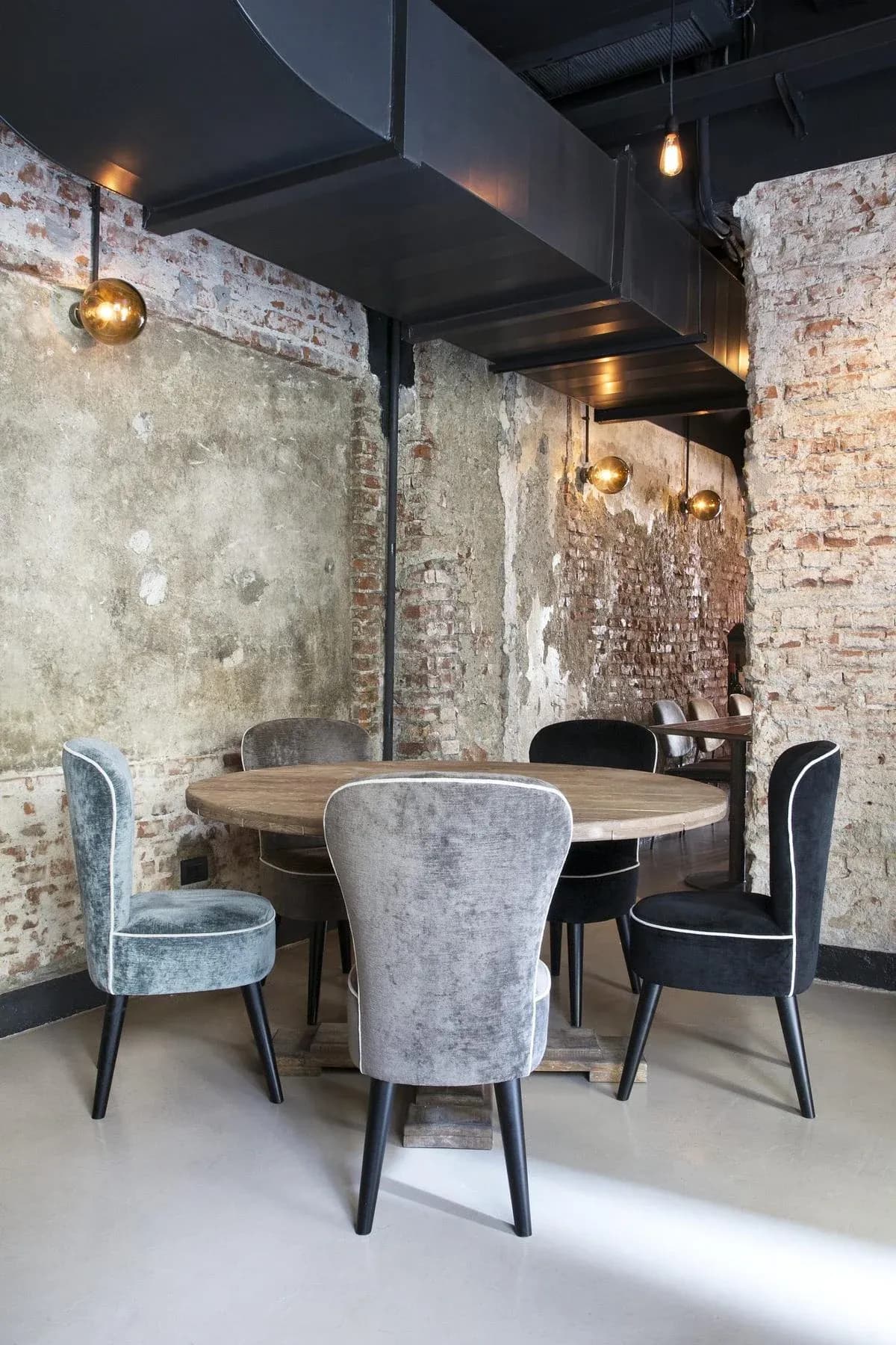 Curved velvet seating brings colour to the restaurant interior.