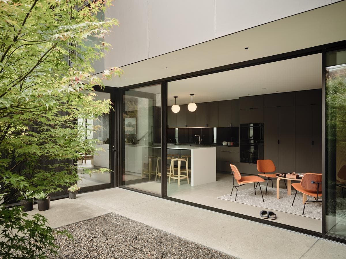 The kitchen and dining area open to a planted courtyard.