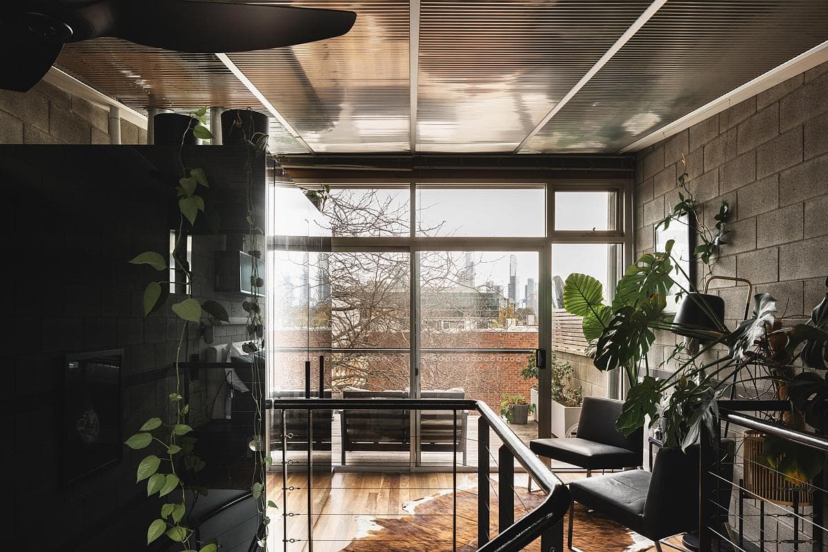 Mirrored surfaces and exposed structure connect the upper interior with the window wall.