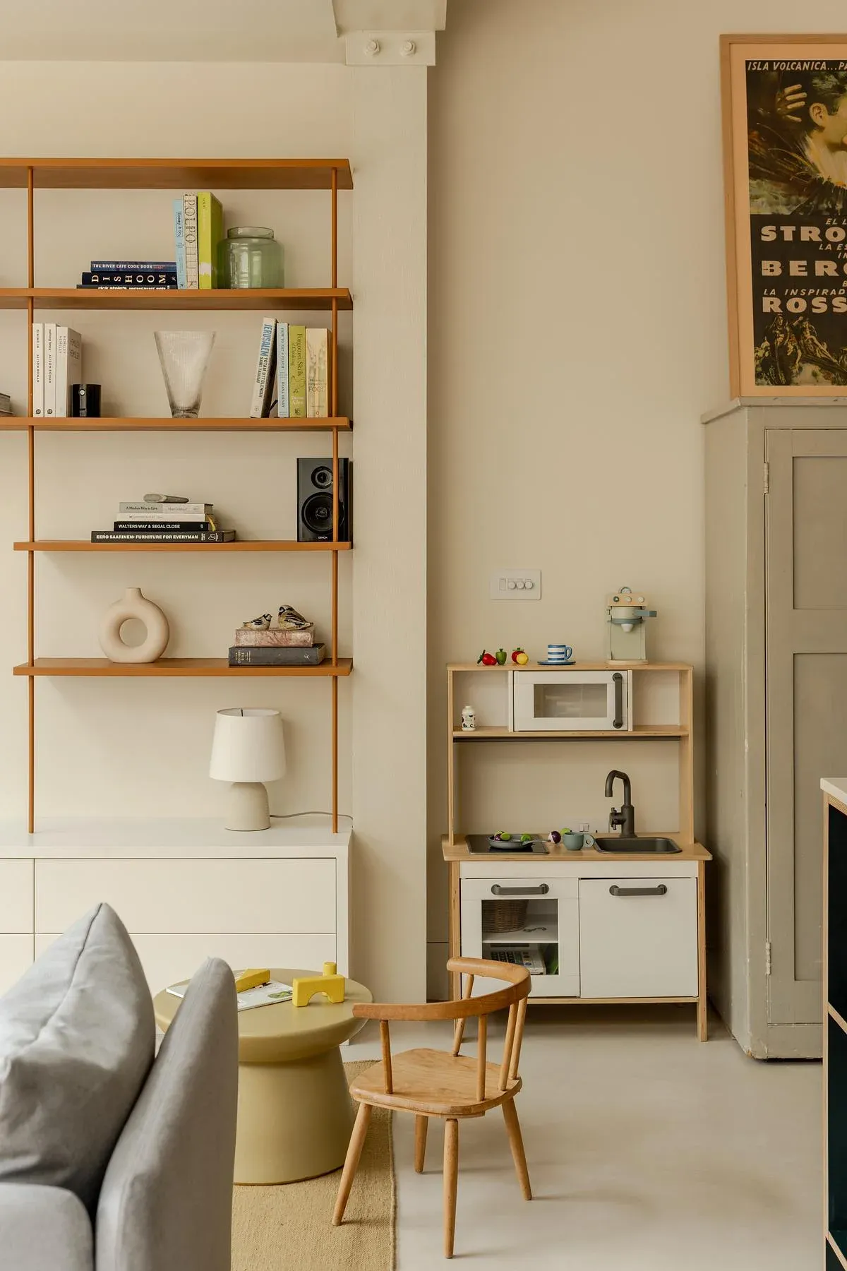 Open shelving and a chair at the edge of the family living space.