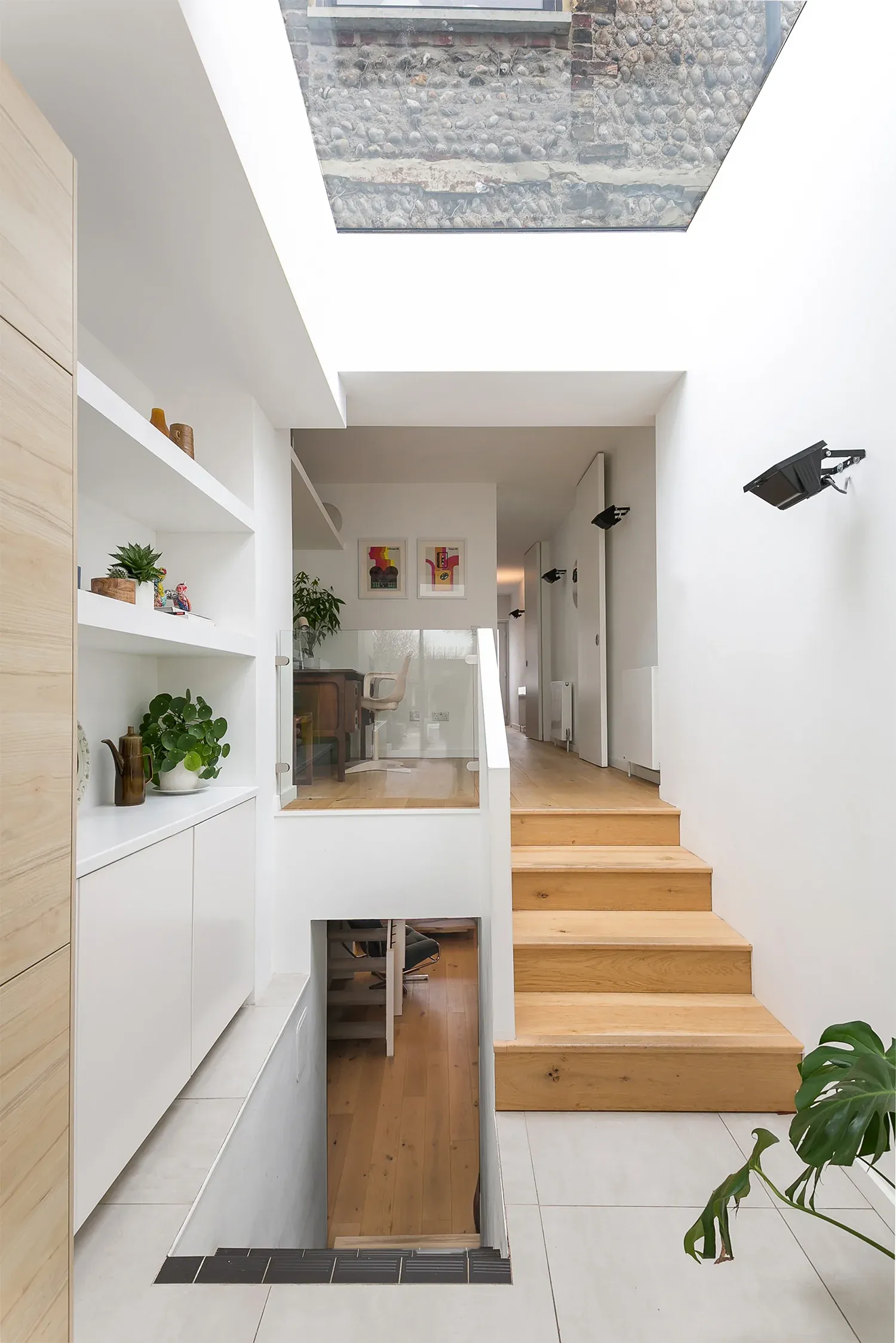 Split levels connect the kitchen with the living room and lower-ground floor.