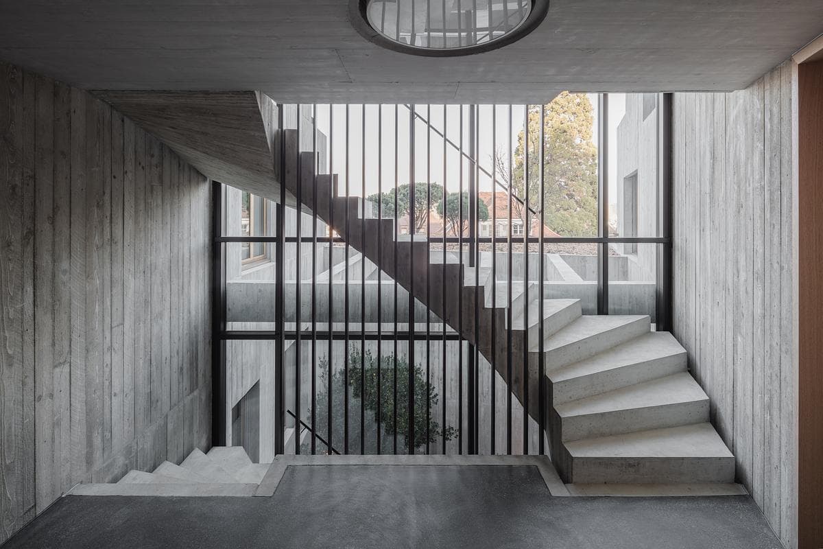 The shared stairwell beside full-height glazing