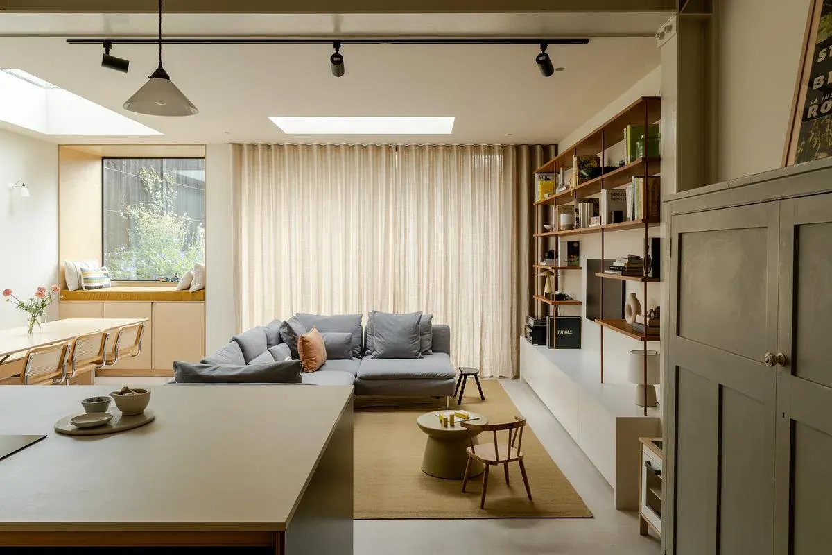 Bookshelves, seating and dining share the open-plan ground floor.