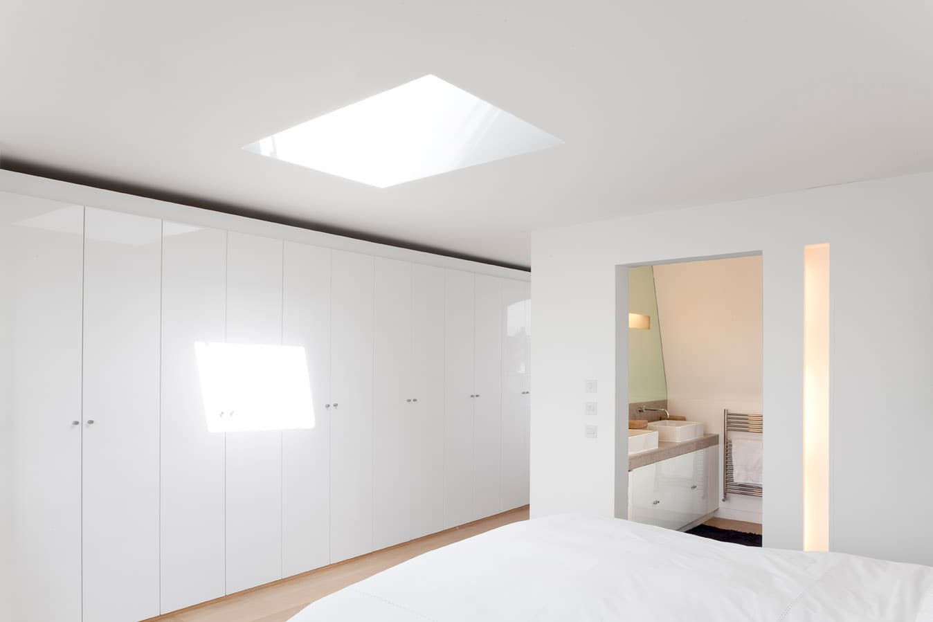 Full-height storage and a rooflight within the rooftop suite