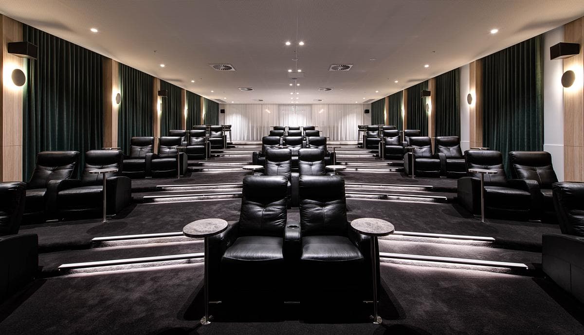 The residents' cinema has rows of reclining leather seats.
