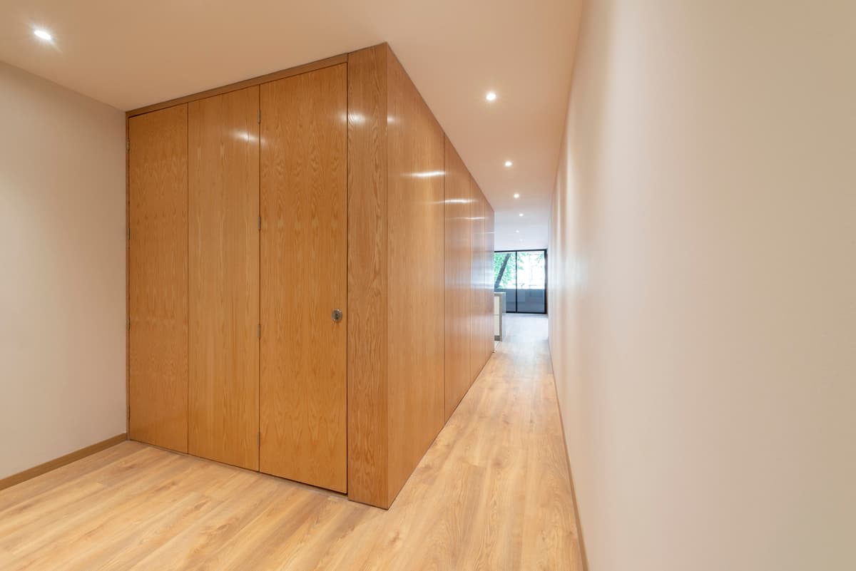 Timber joinery defines a passage between rooms.
