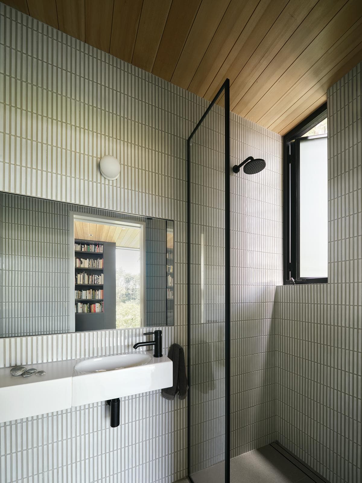 Pale tiles and a long vanity in the bathroom.