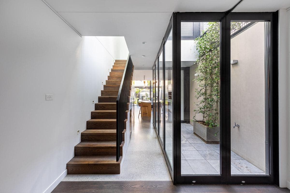 Glazing opens the stair and living spaces towards the courtyard.