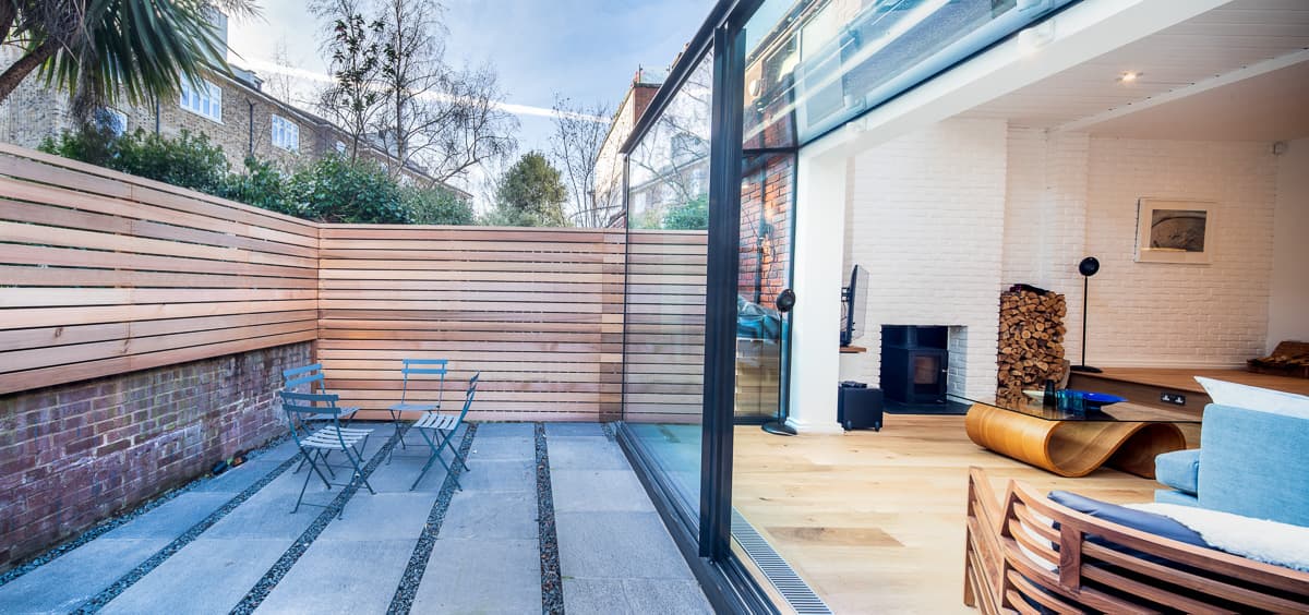 The rear living space opens onto an enclosed terrace