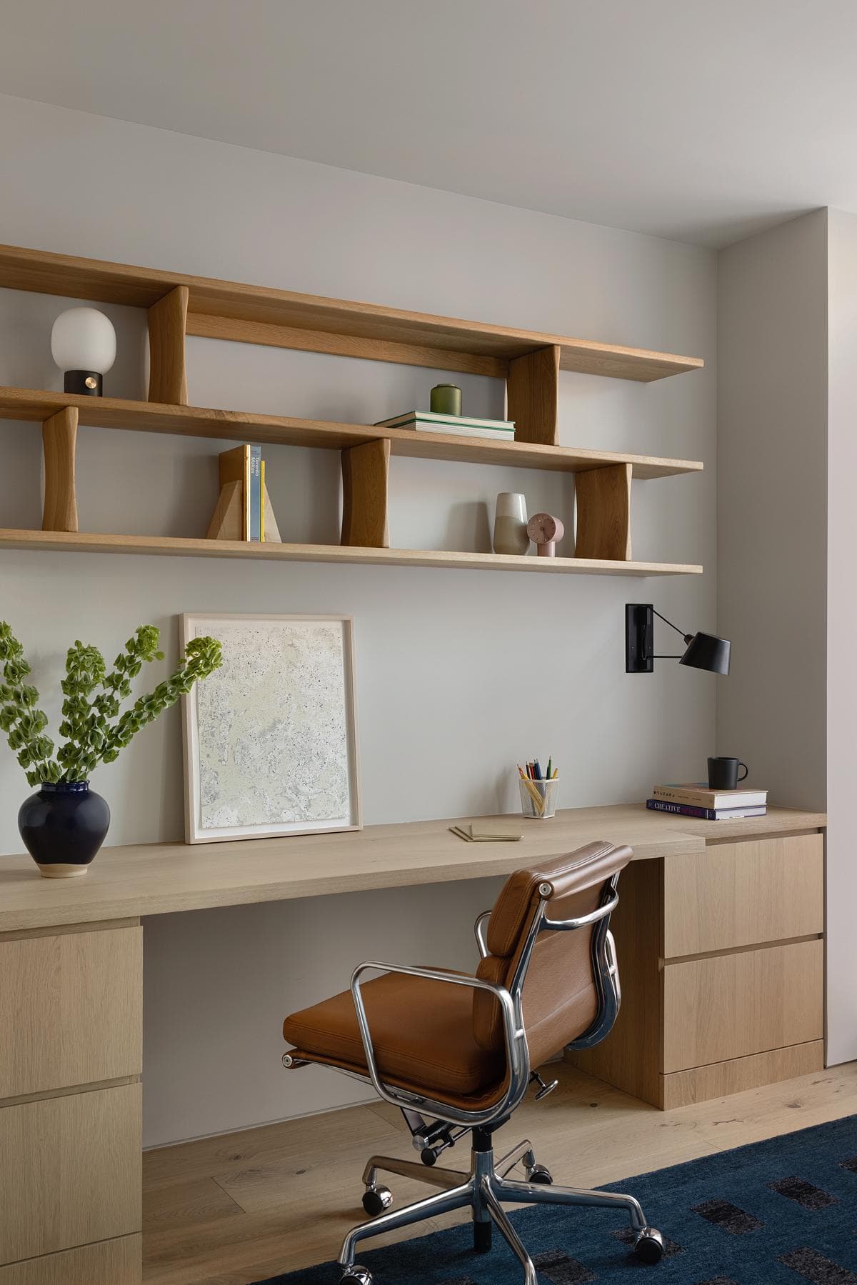 Fitted joinery creates a compact place to work beside a window.