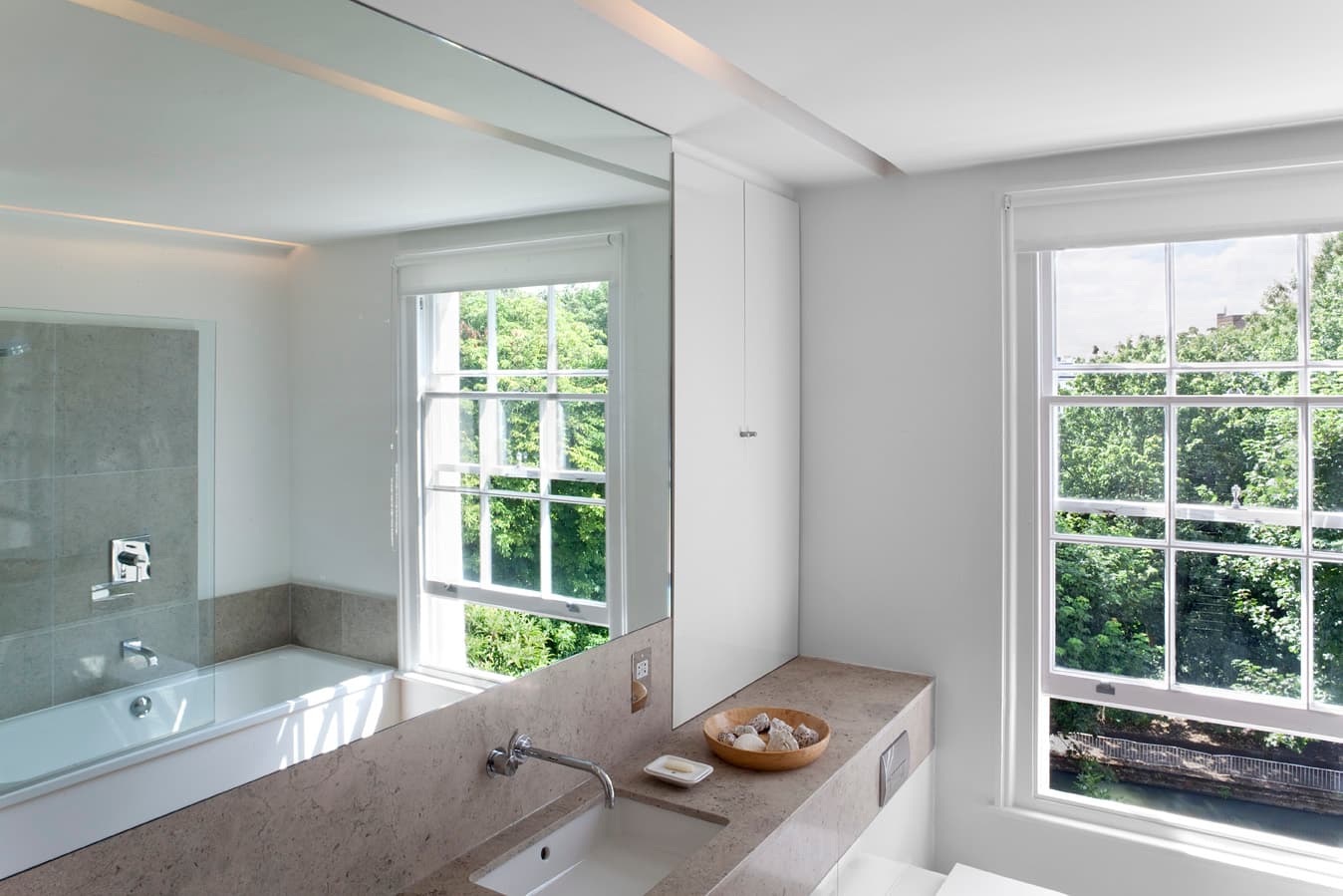 The bathroom combines a rooflight with a view towards the canal