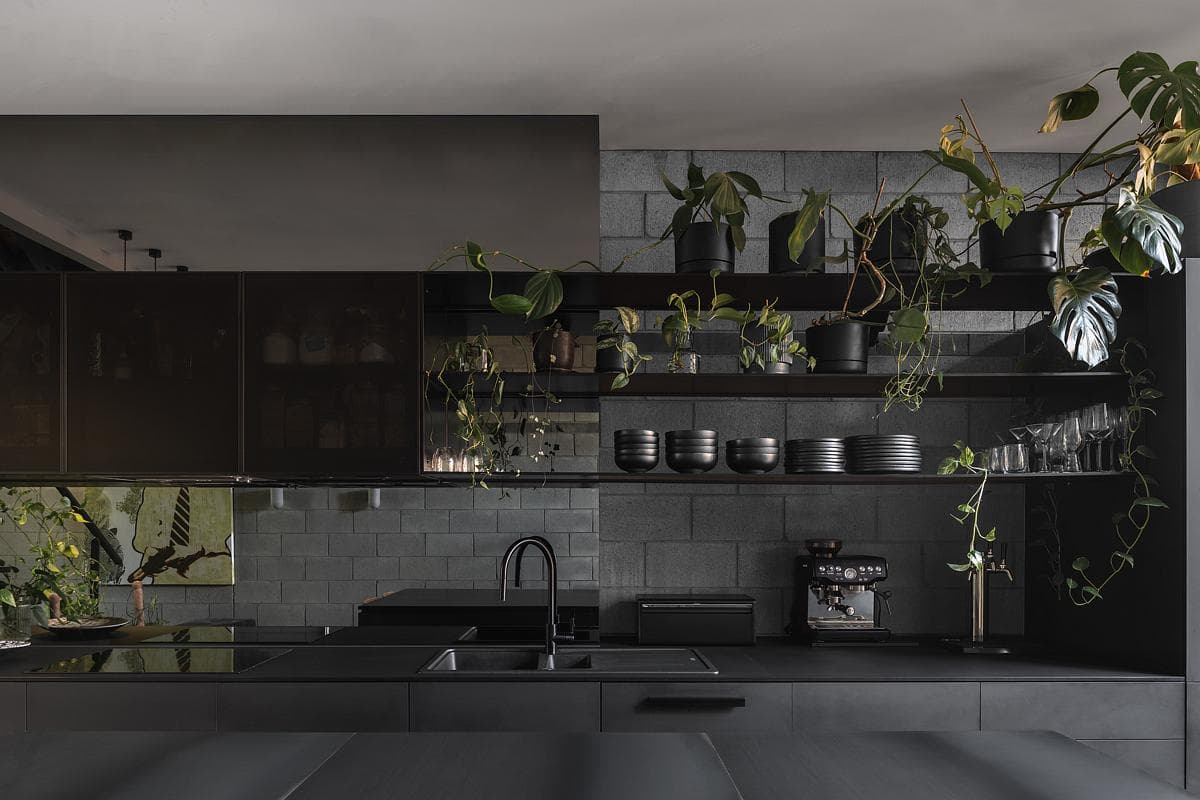 Dark cabinetry sits against the existing blockwork in the kitchen.