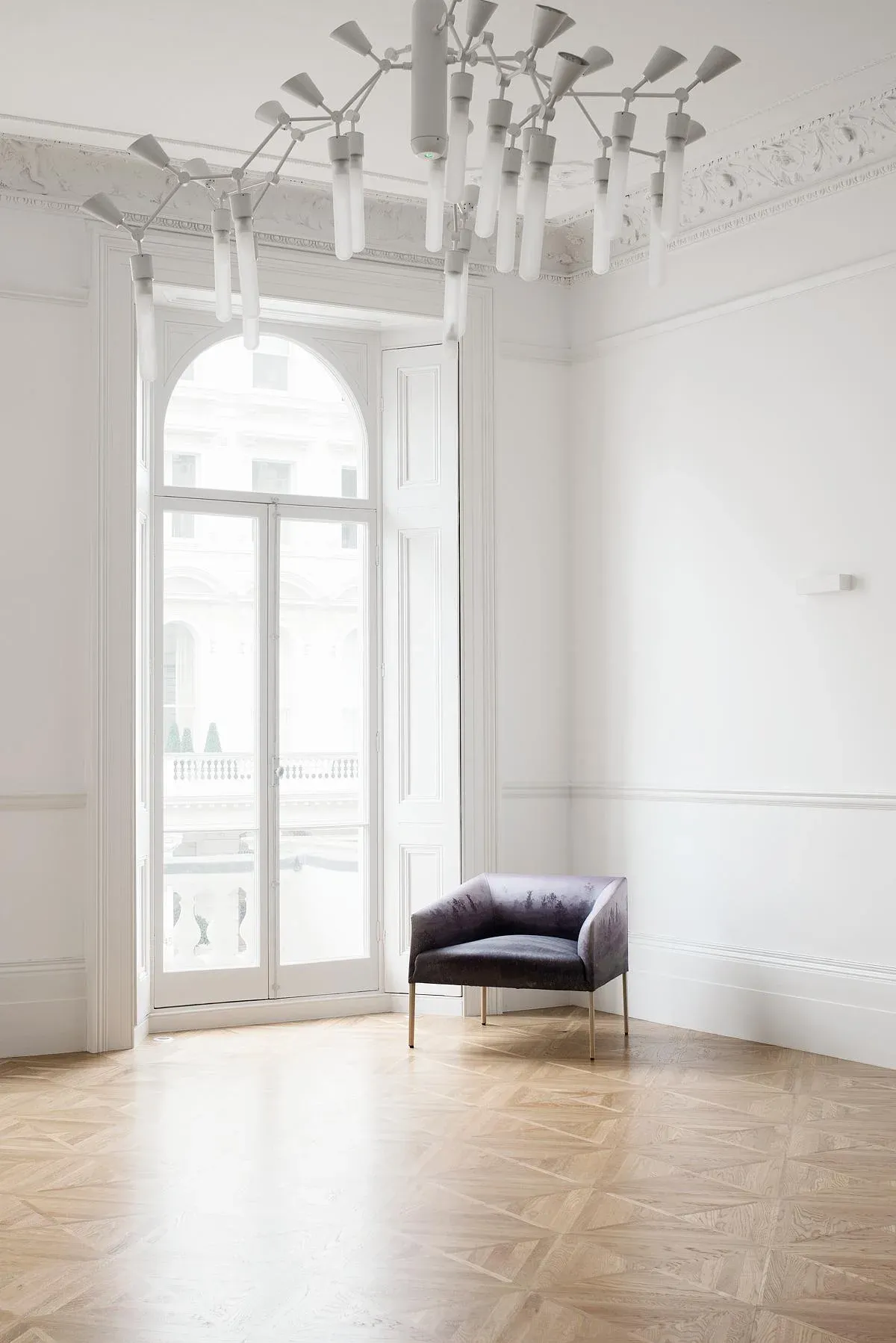 An arched window and armchair in the embassy reception rooms.