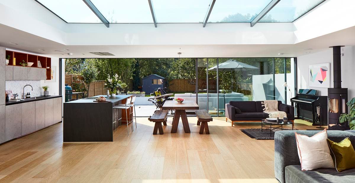 Living and dining space with full-height glazing towards the garden.
