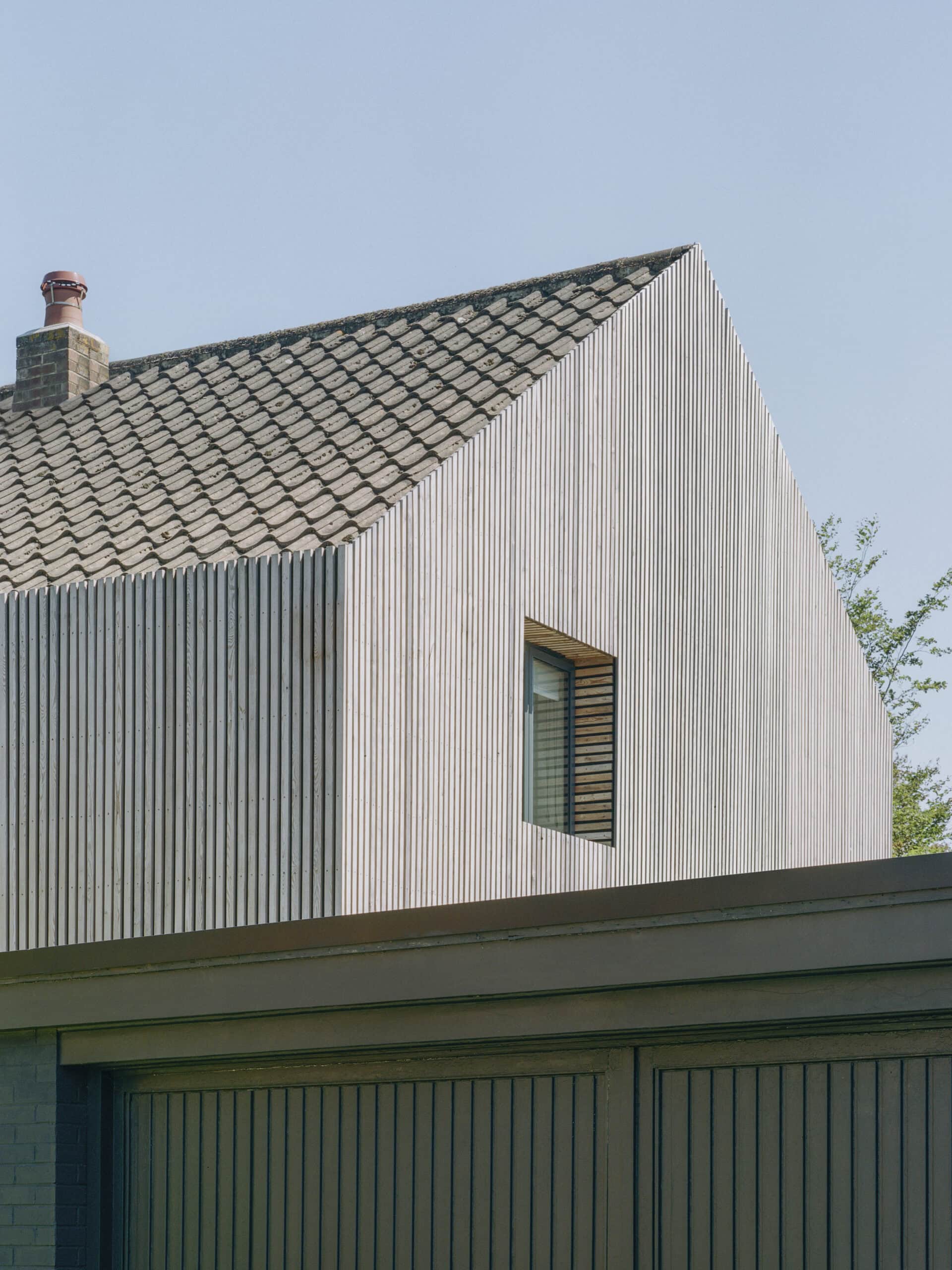 Timber-clad upper facade.