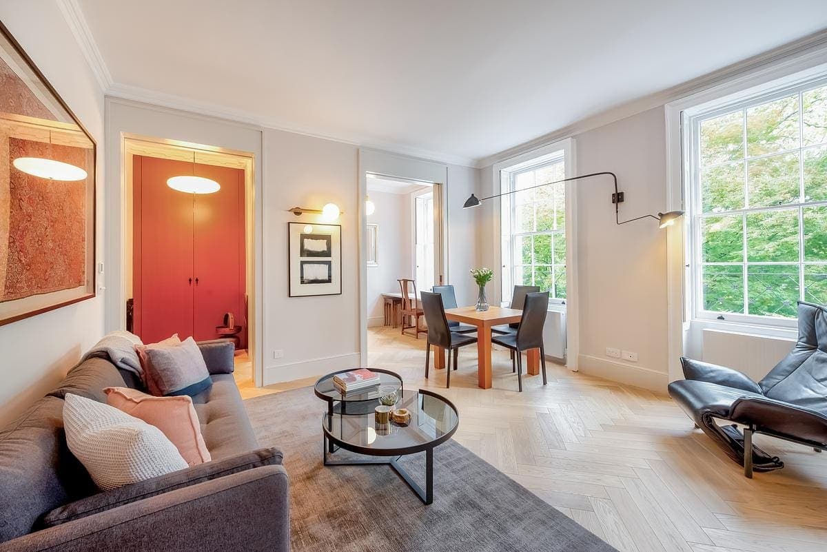 Tall sliding pocket doors and oak detailing at Highbury Apartment by Patalab Architects