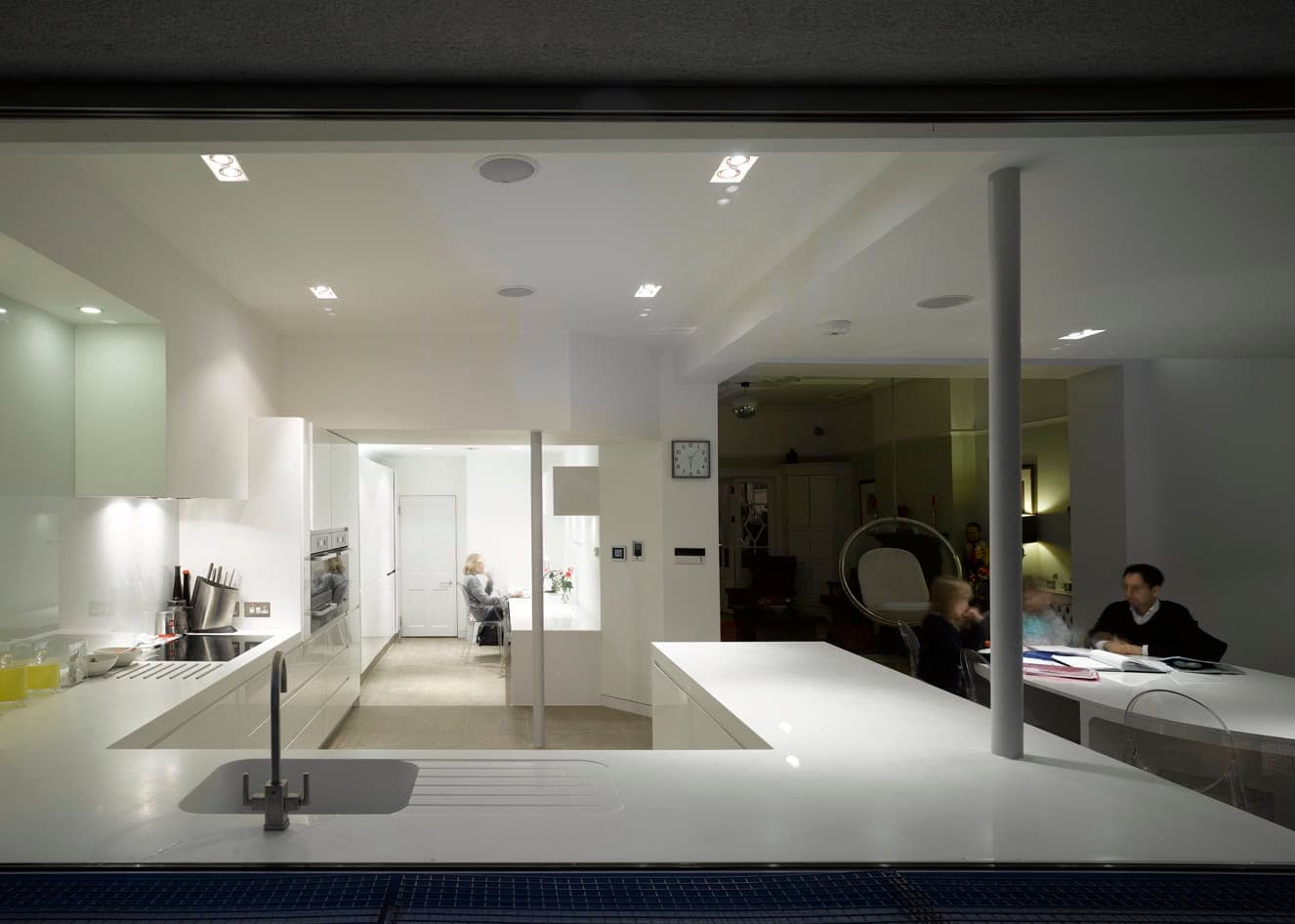 Kitchen interior illuminated at night.