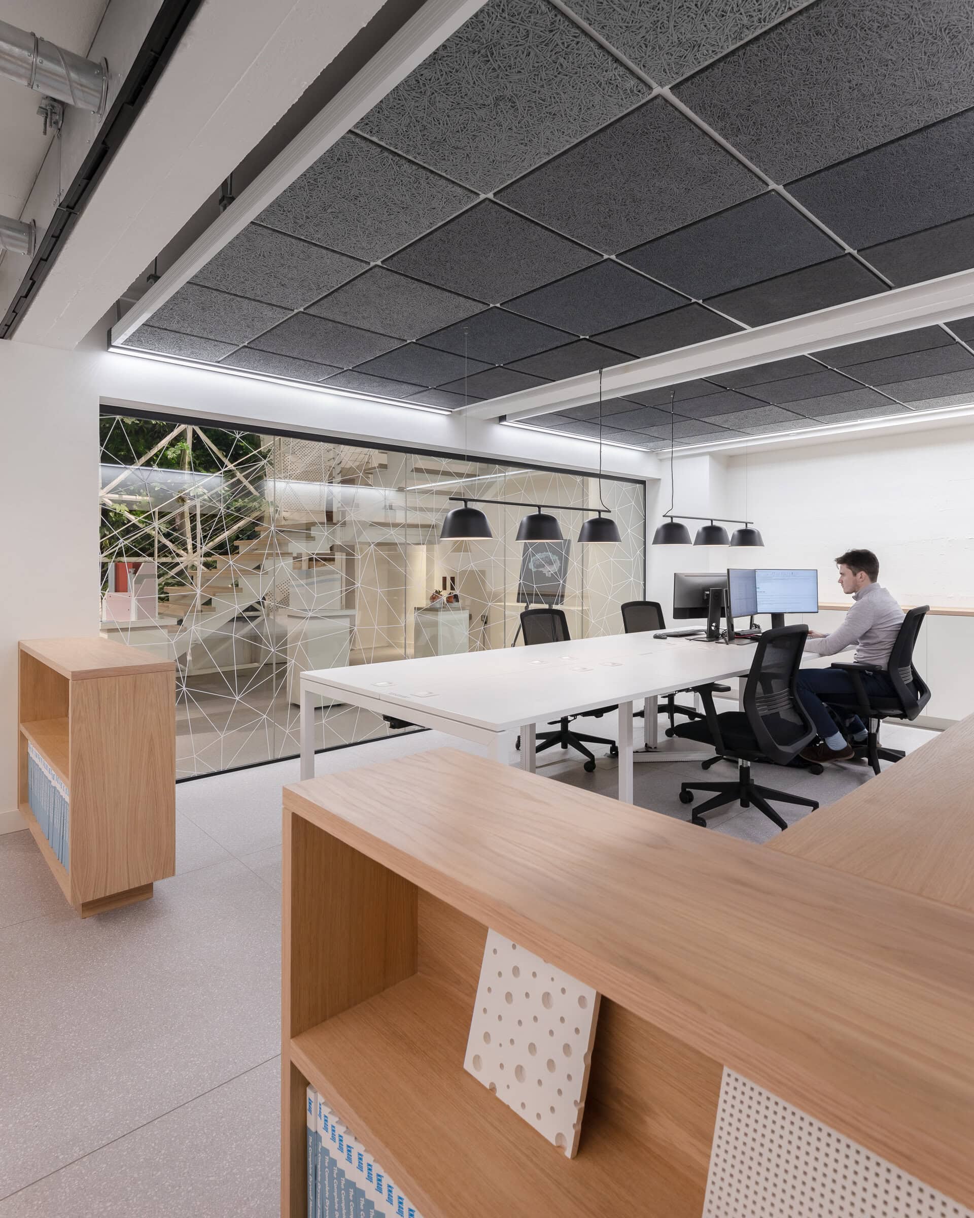 Work tables below the exposed ceiling.