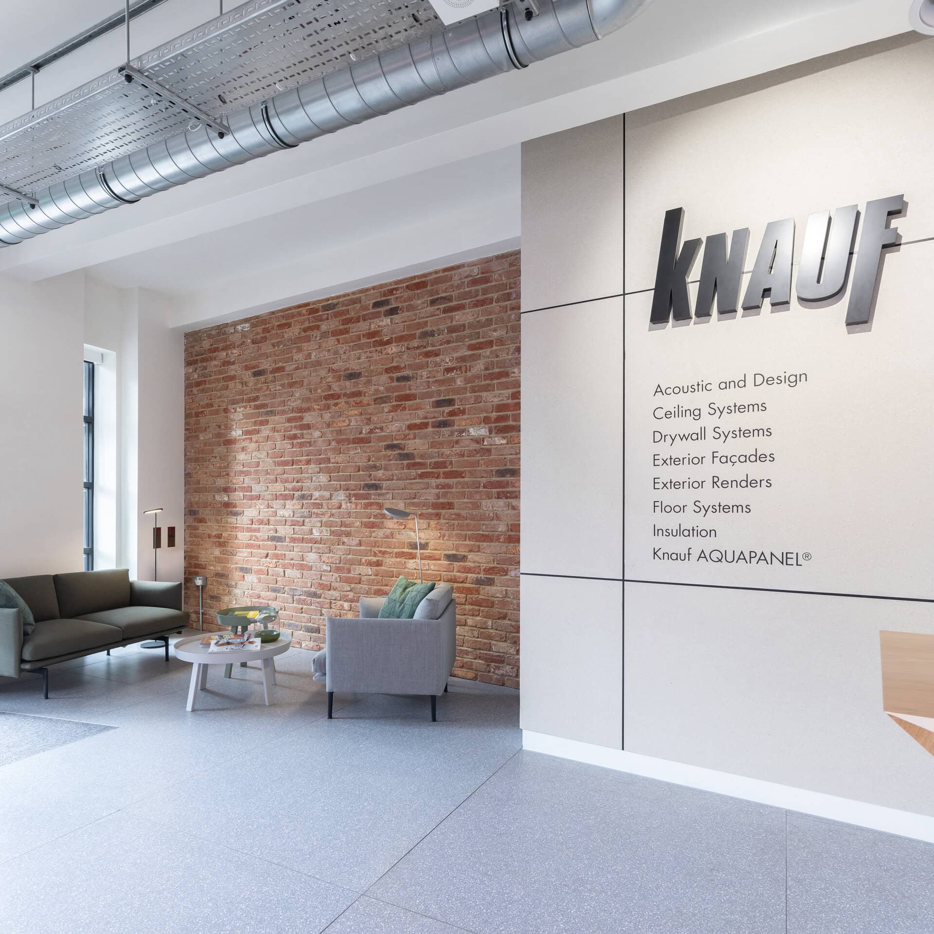 Branded reception wall and lounge seating.