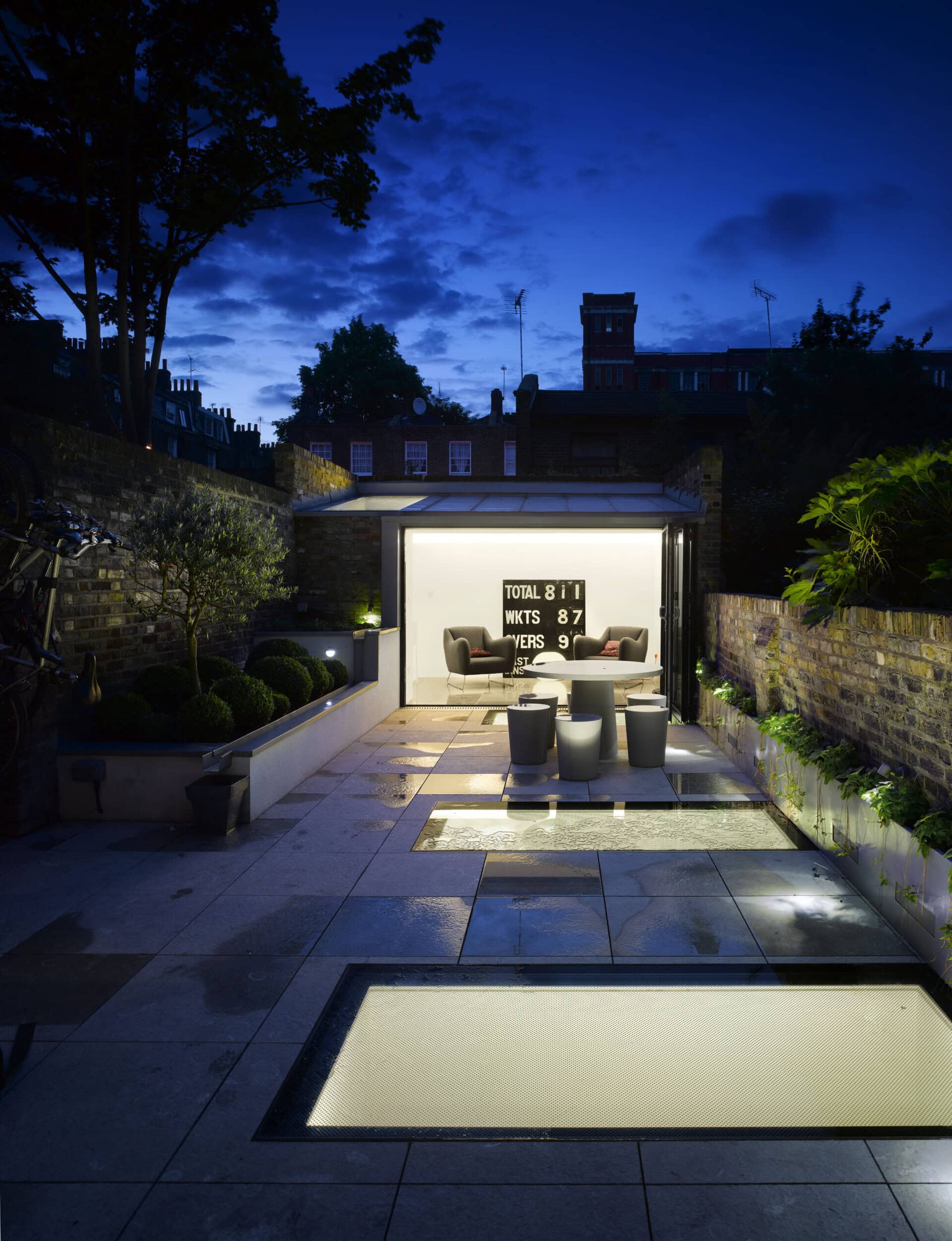 Illuminated garden room at night.
