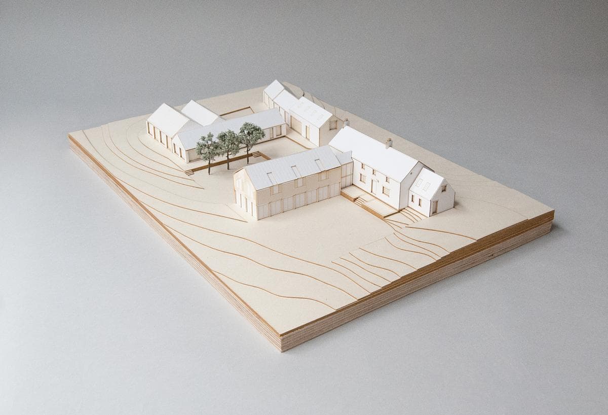 Physical architectural model showing the house, adjoining buildings and site contours.