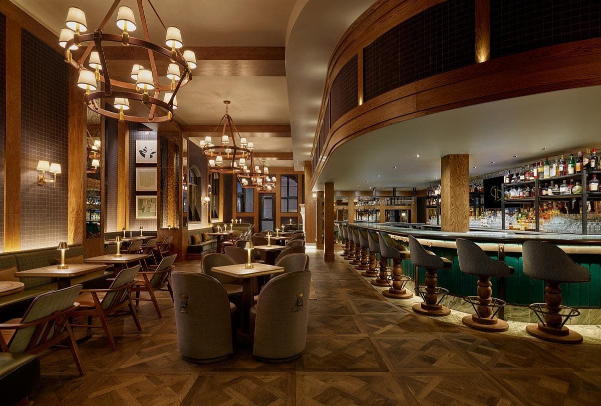 Upscale bar and restaurant interior with elegant decor, warm lighting, and sophisticated atmosphere.