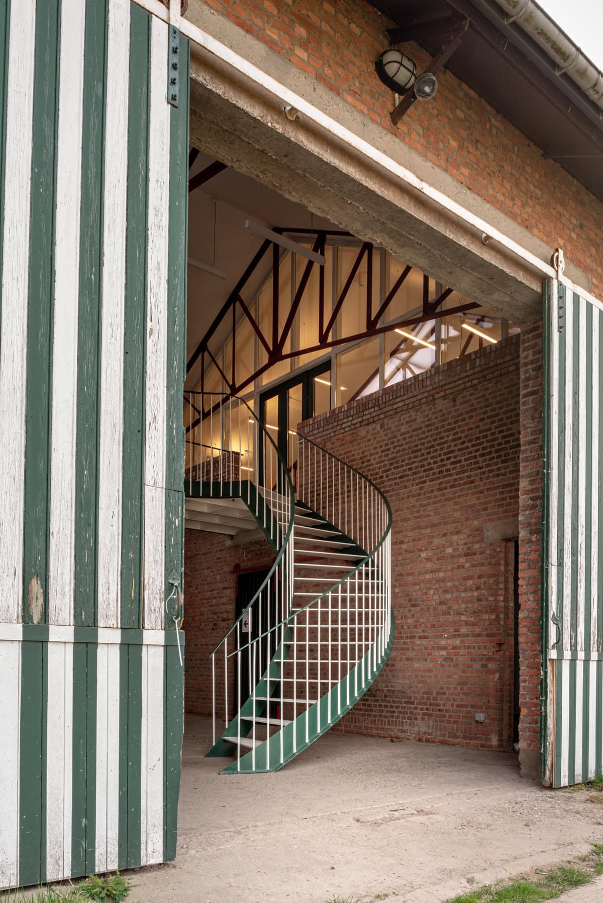 Stylish barn featuring modern spiral staircase and charming rustic design elements.