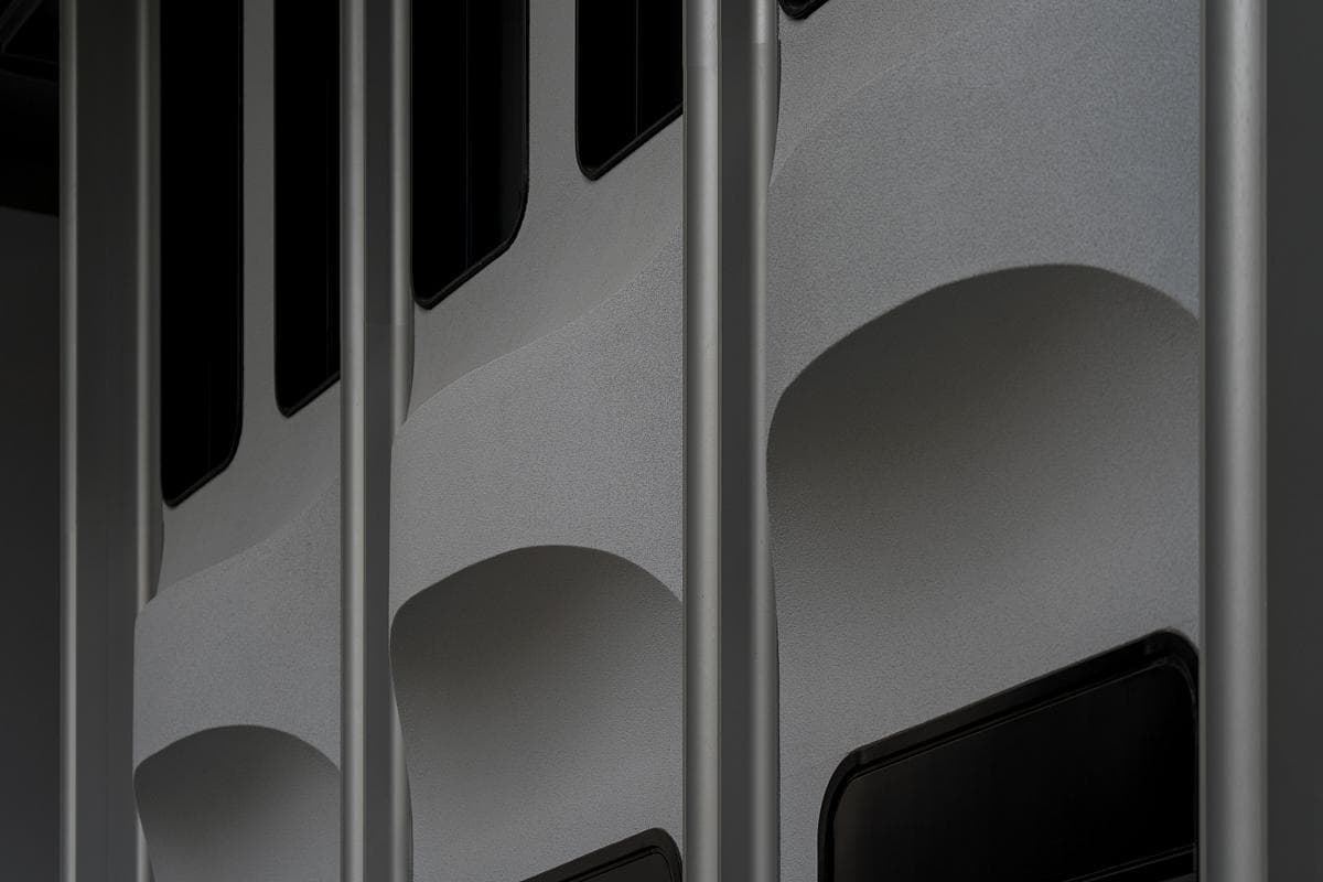 Abstract metal bars and arches create intriguing contrasts of confinement and openness.