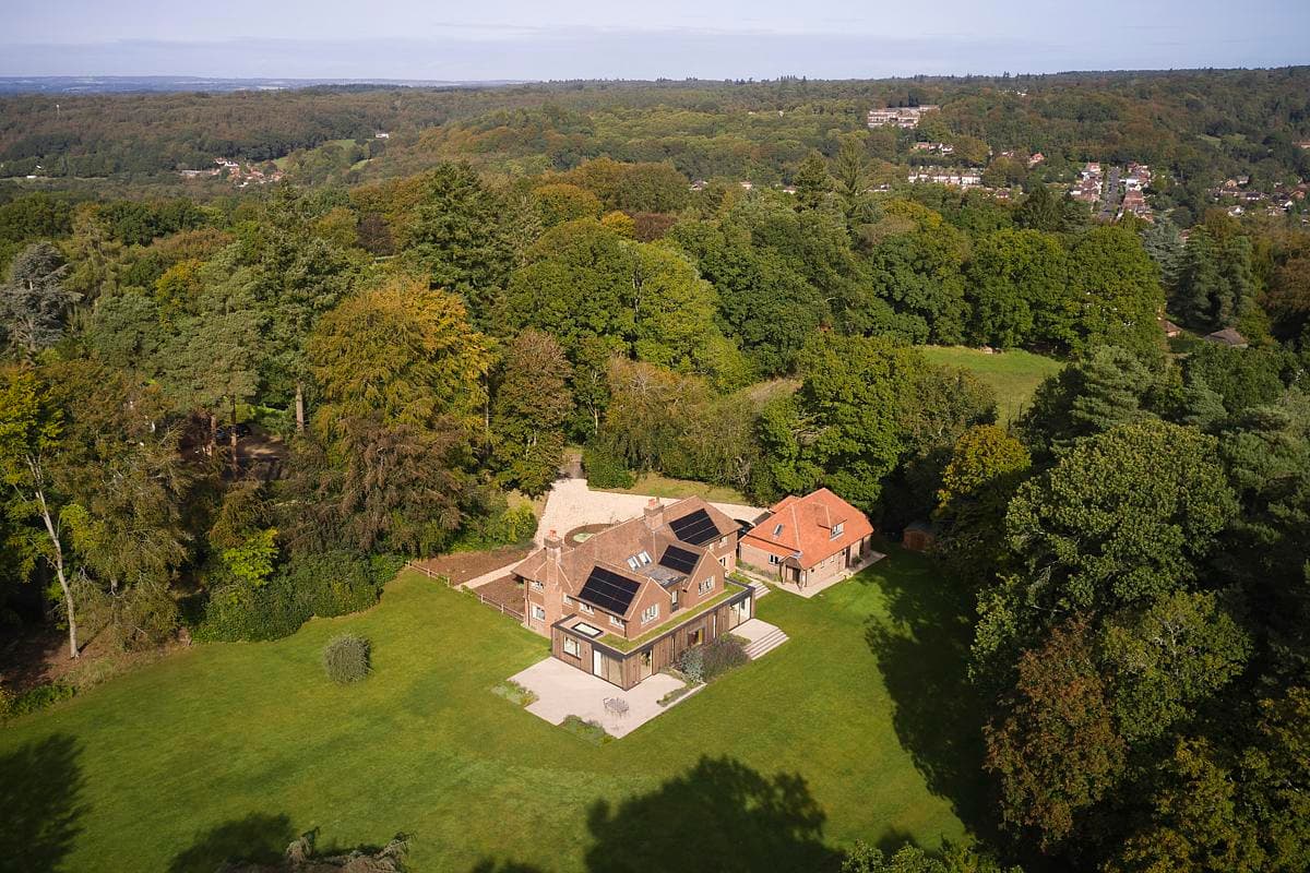 Charming eco-friendly home surrounded by lush greenery in a tranquil wooded setting.