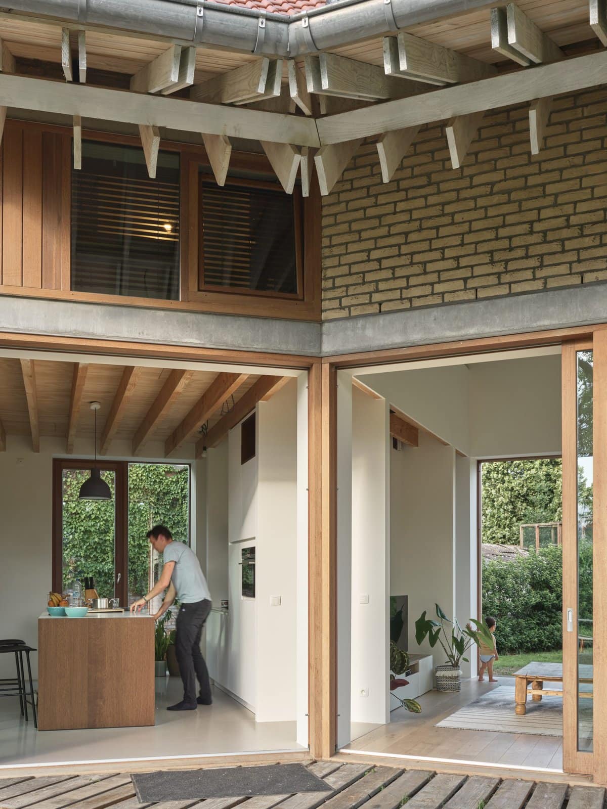 Modern open-concept home with bright kitchen, cozy living area, and large sliding glass doors.