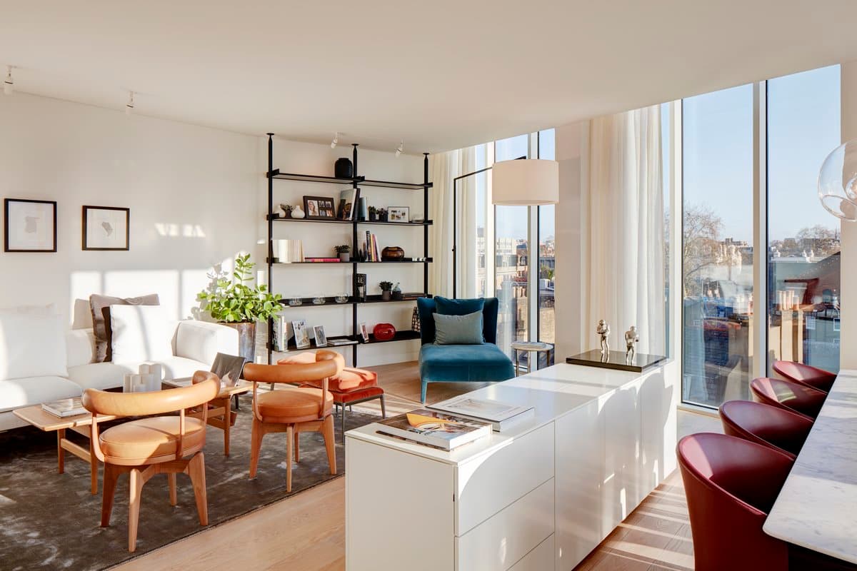 Modern open-plan living room with natural light, stylish furniture, and a view of a suburban neighbourhood.