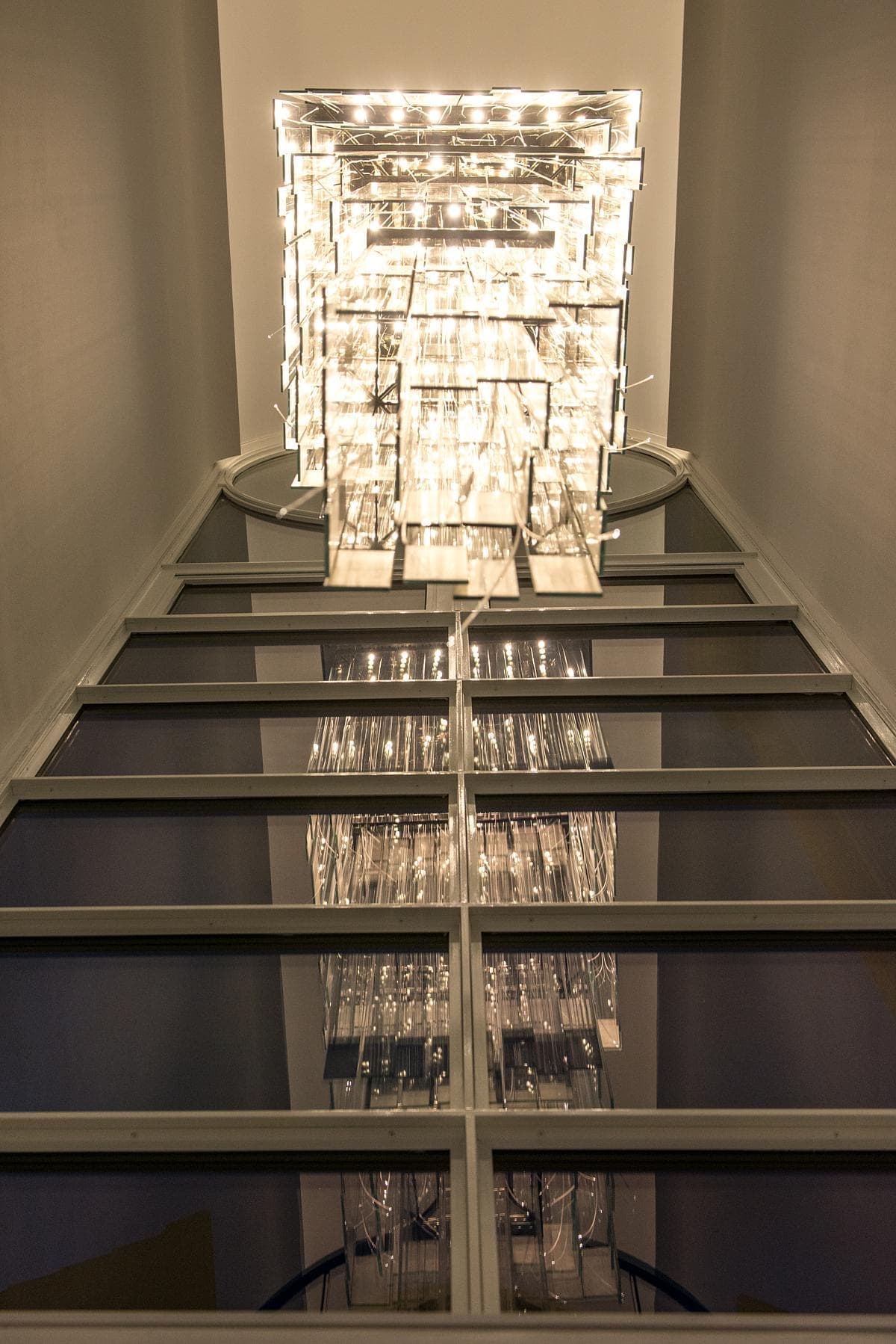 Stylish atrium featuring an elegant modern chandelier that enhances the luxurious ambiance.