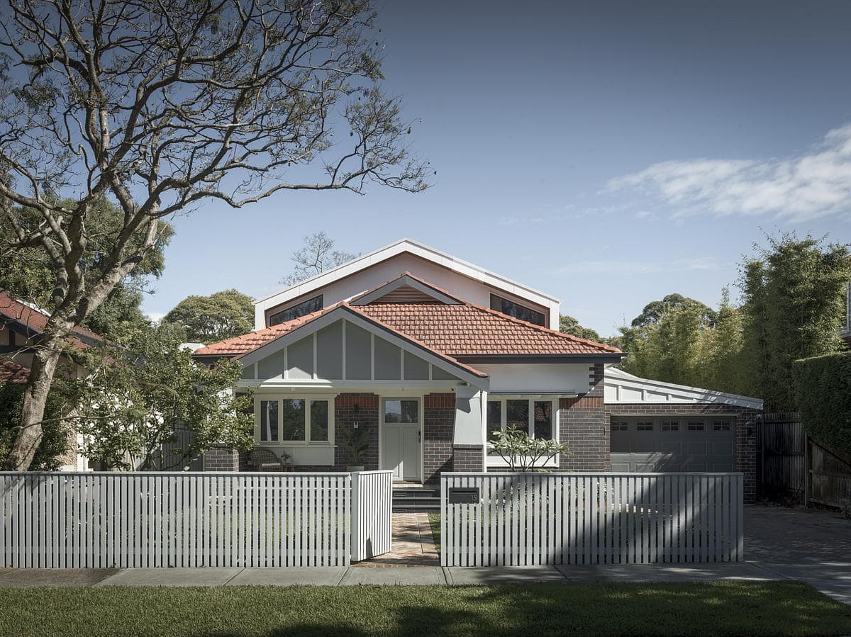 Modern home with traditional elements, featuring a charming gabled roof and inviting porch.