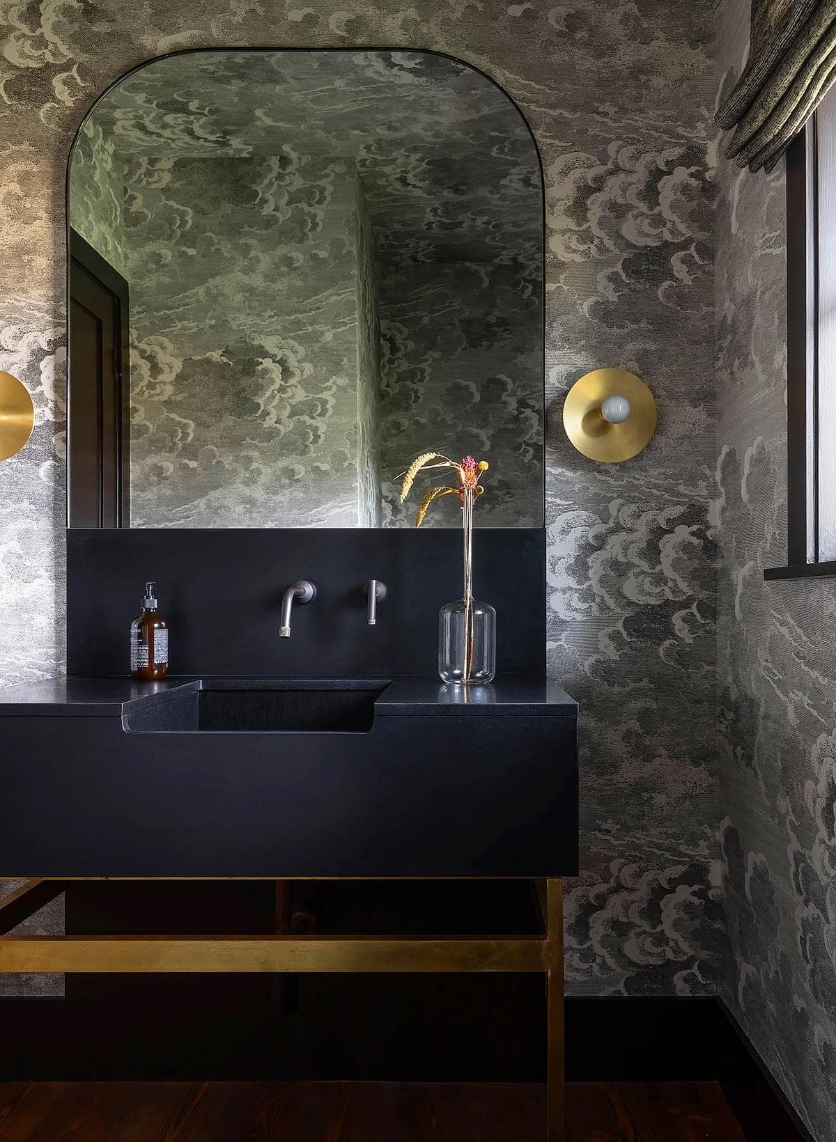 Contemporary bathroom with elegant grey wallpaper and minimalist black vanity design.