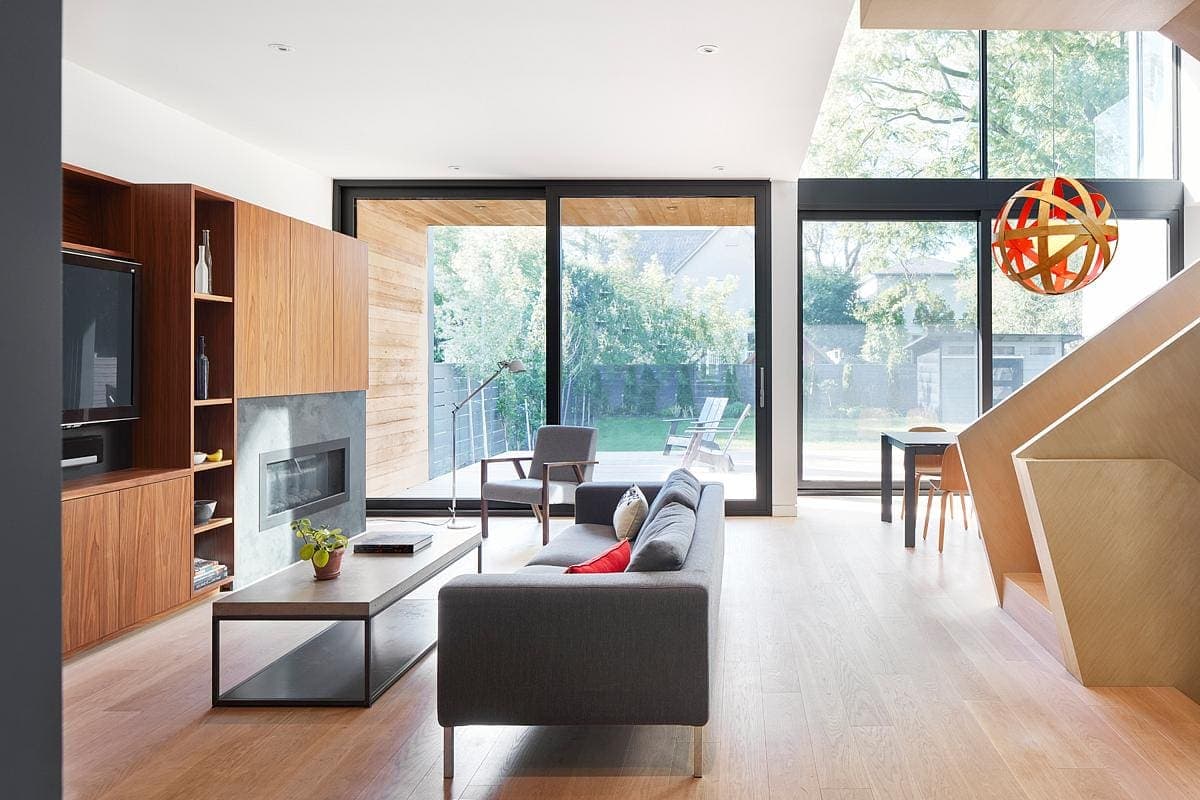 Modern living room with natural light, glass doors, and minimalist decor.