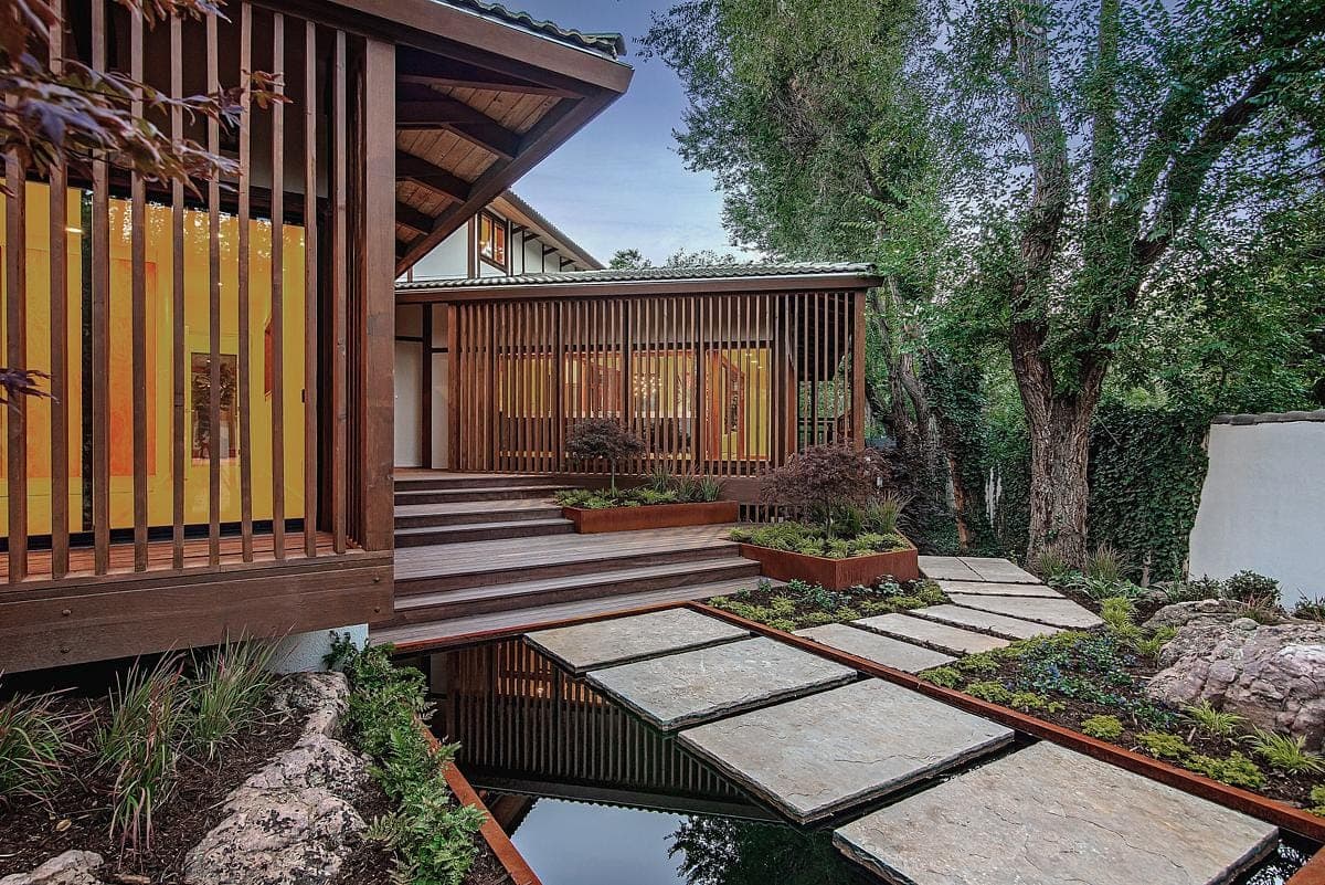 Modern wooden house seamlessly integrates with nature, featuring stunning architecture and serene landscaping.