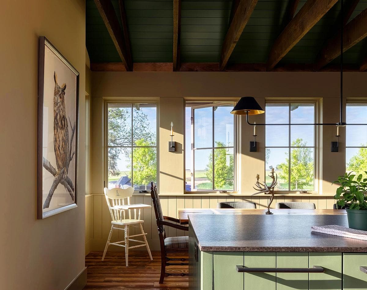 Inviting kitchen and dining area with natural light, rustic beams, and charming decor.