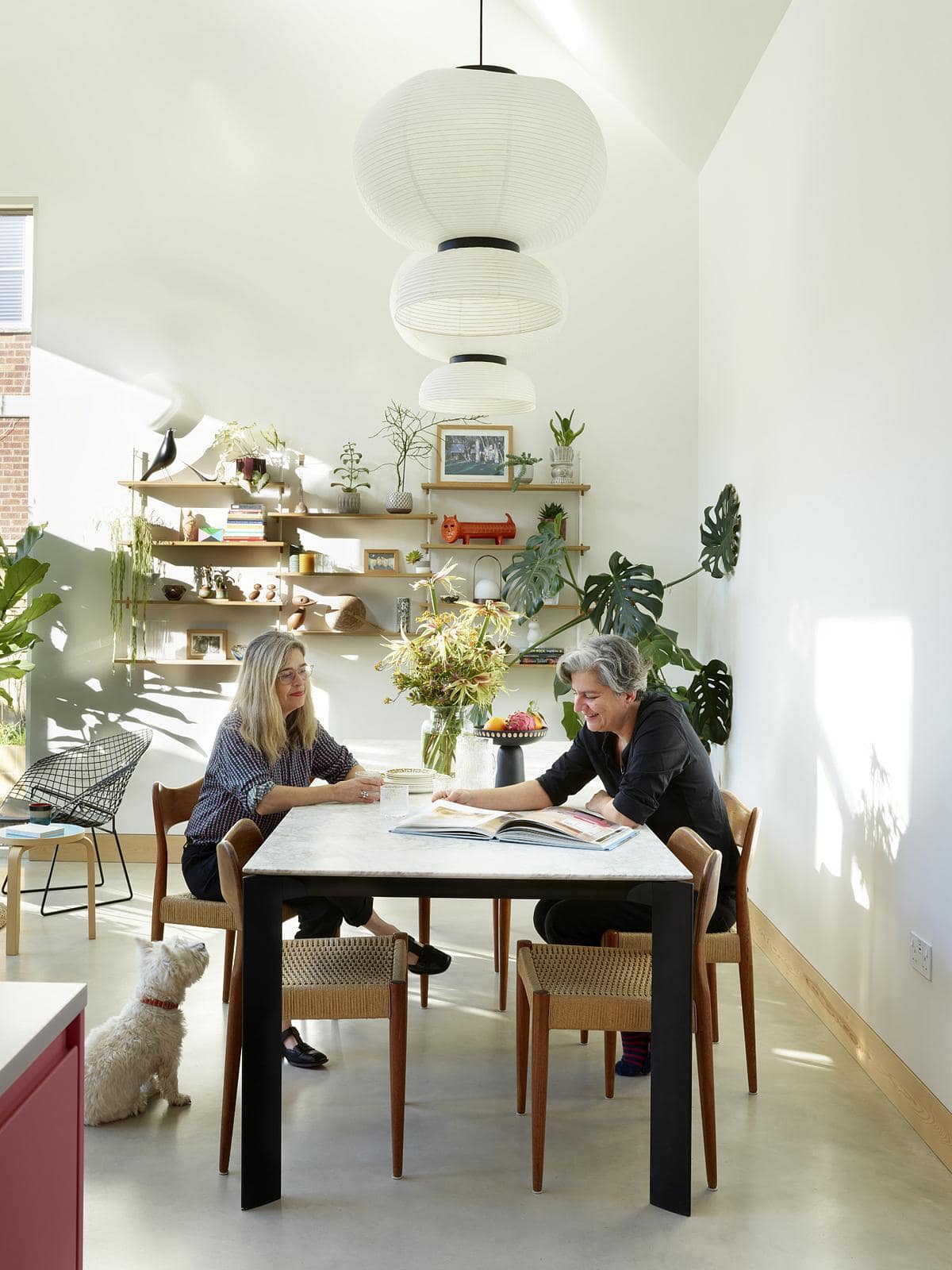 Bright modern kitchen dining area with natural light, stylish decor, and a relaxed atmosphere.